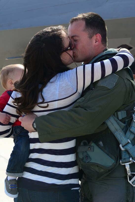 U.S. Air Force Capt. Mike Coleman, 94th Fighter Squadron F-22 Raptor pilot, greets his wife Erin and son Mitch at Langley Air Force Base, Va., April 17, 2014, upon returning from a deployment. Coleman participated in Theater Security Package training while deployed to Kadena Air Base, Japan. (U.S. Air Force photo by Airman 1st Class Kimberly Nagle/Released) 