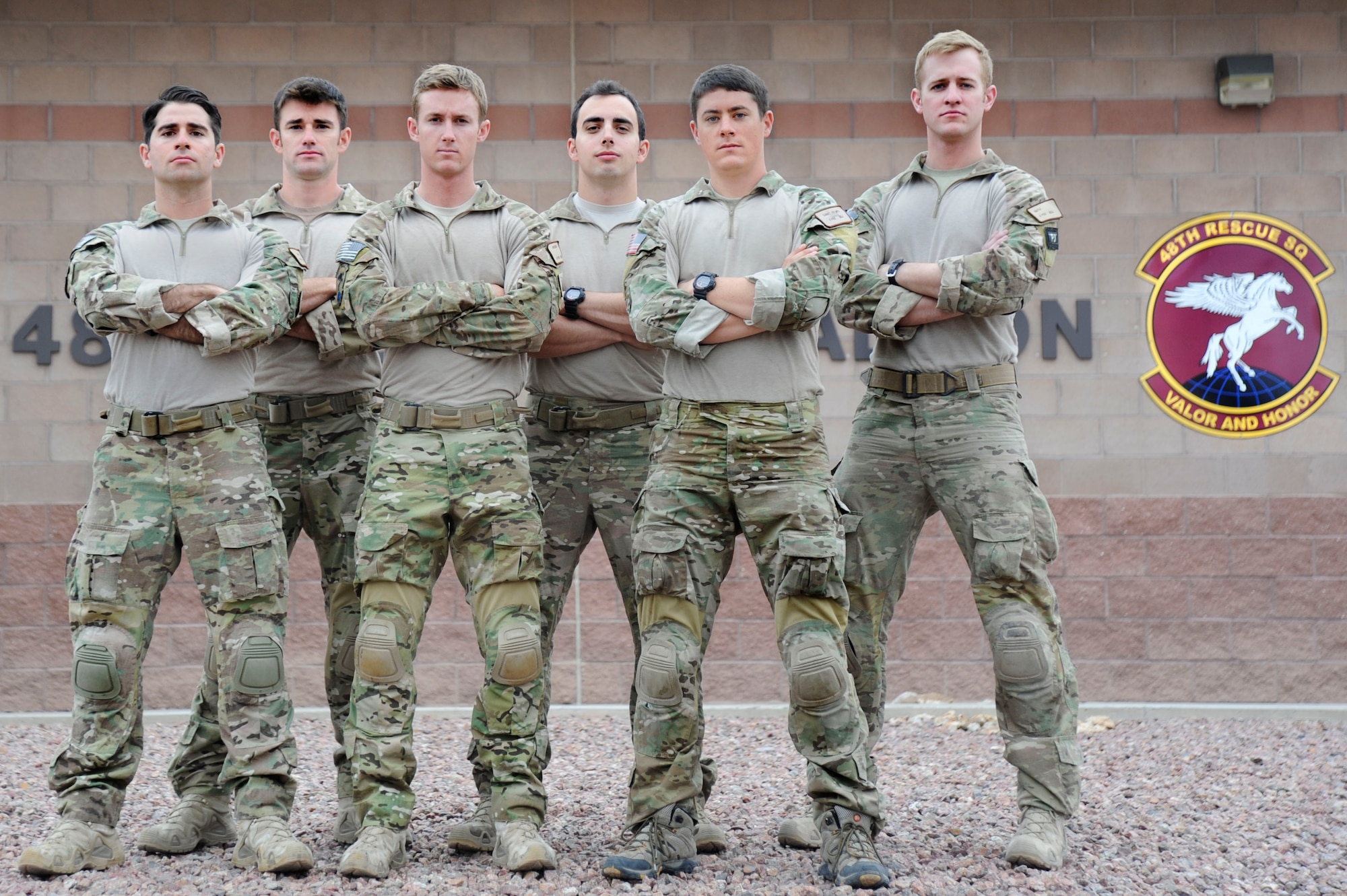 U.S. Air Force Airmen Micah, Adam, Dan, Jesse, Kenny and Wes, 48th Rescue Squadron pararescuemen, pose in front of the 48th RQS building at Davis-Monthan Air Force Base, Ariz., April 18, 2014. The pararescuemen aided a man who had a heart attack in front of the 48th RQS static display during the Thunder and Lightning over Arizona event, April 12. (U.S. Air Force photo by Airman 1st Class Betty R. Chevalier/released)