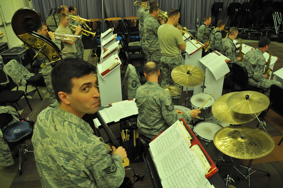 Staff Sergeant Andy Peck, bassist with the Air Force Band of the Golden West, glances at the camera during a rehearsal with The Commanders jazz ensemble in the band's rehearsal hall at Travis Air Force Base, California. March, 2014