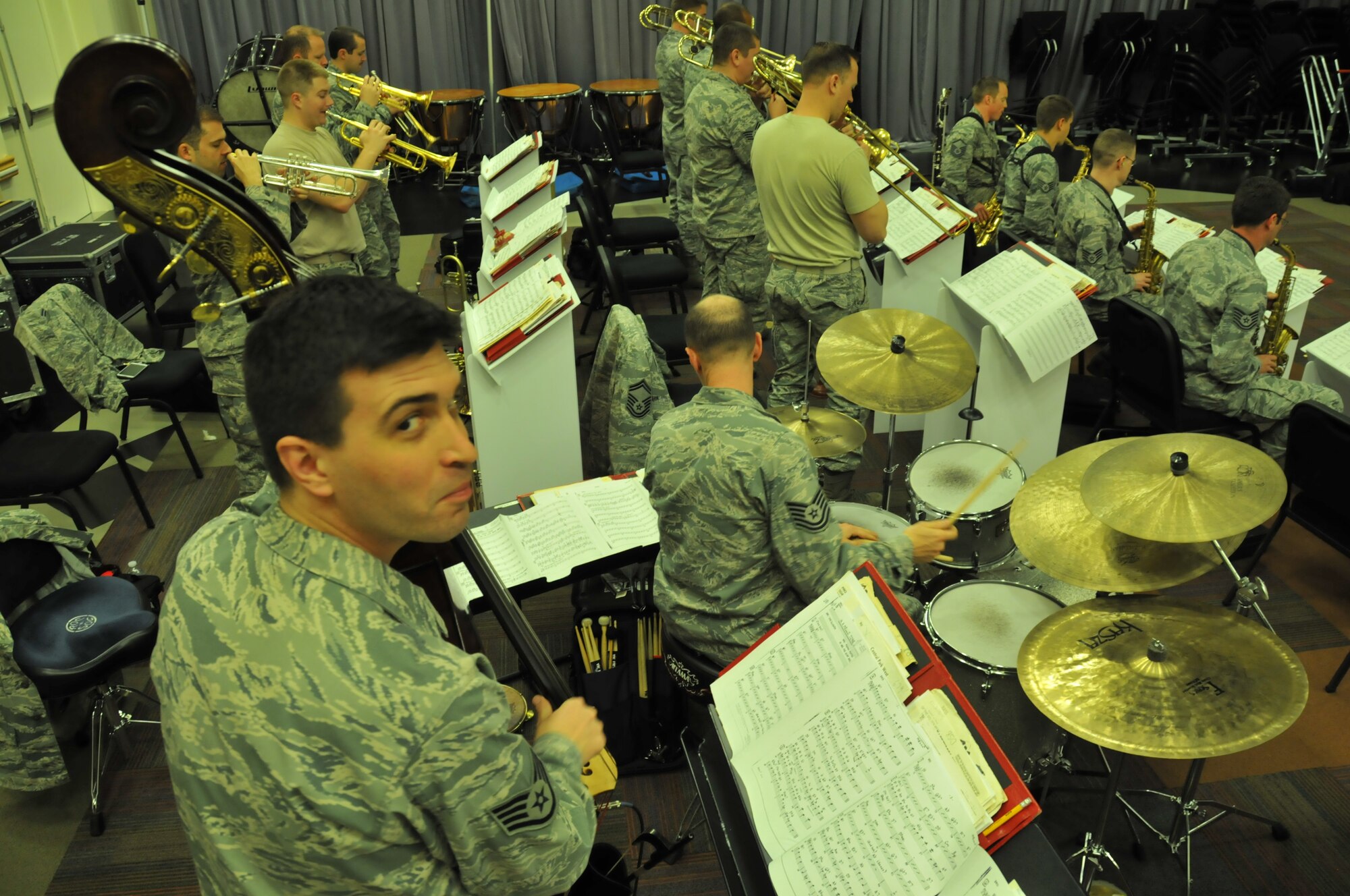 Staff Sergeant Andy Peck, bassist with the Air Force Band of the Golden West, glances at the camera during a rehearsal with The Commanders jazz ensemble in the band's rehearsal hall at Travis Air Force Base, California. March, 2014