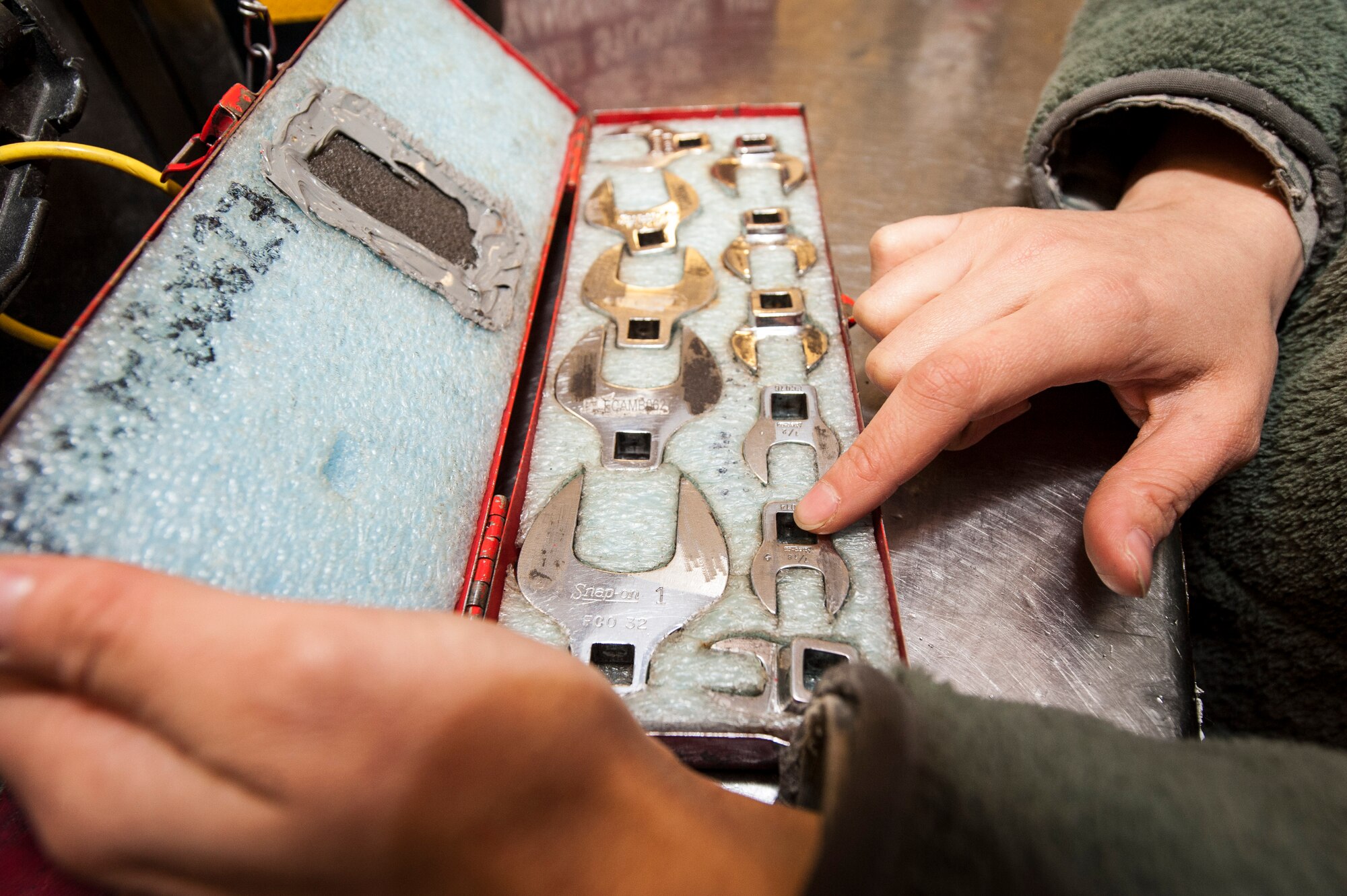 Senior Airman Shelby Kenny inspects her tools before signing them out for duty from the 92nd Aircraft Maintenance Squadron’s consolidated tool kit at Fairchild Air Force Base, Wash., April 16, 2014. The 92nd AMXS CTK shop handles an average of nearly 5,000 tools every day. Kenny is a 92nd AMXS electrical and environmental specialist and Sioux Falls, S.D., native. (U.S. Air Force photo by Staff Sgt. Benjamin W. Stratton/Released)