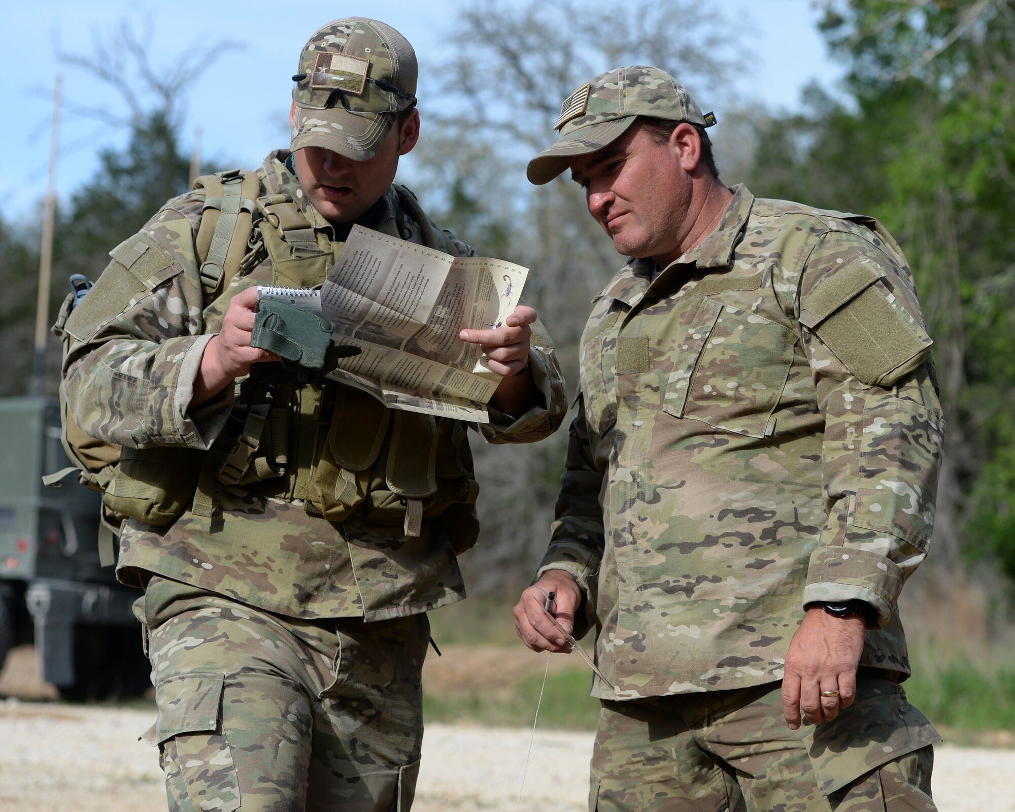 Two tactical air control party members from the 147th Air Support Operations Squadron, 147th Reconnaissance Wing, based at Ellington Field Joint Reserve Base in Houston, Texas, prepare to navigate to their first point during a land navigation exercise at Camp Swift in Bastrop, Texas. The squadron travelled to the camp to perform a weeklong field training exercise that allowed the members to maintain their proficiency in their career field.