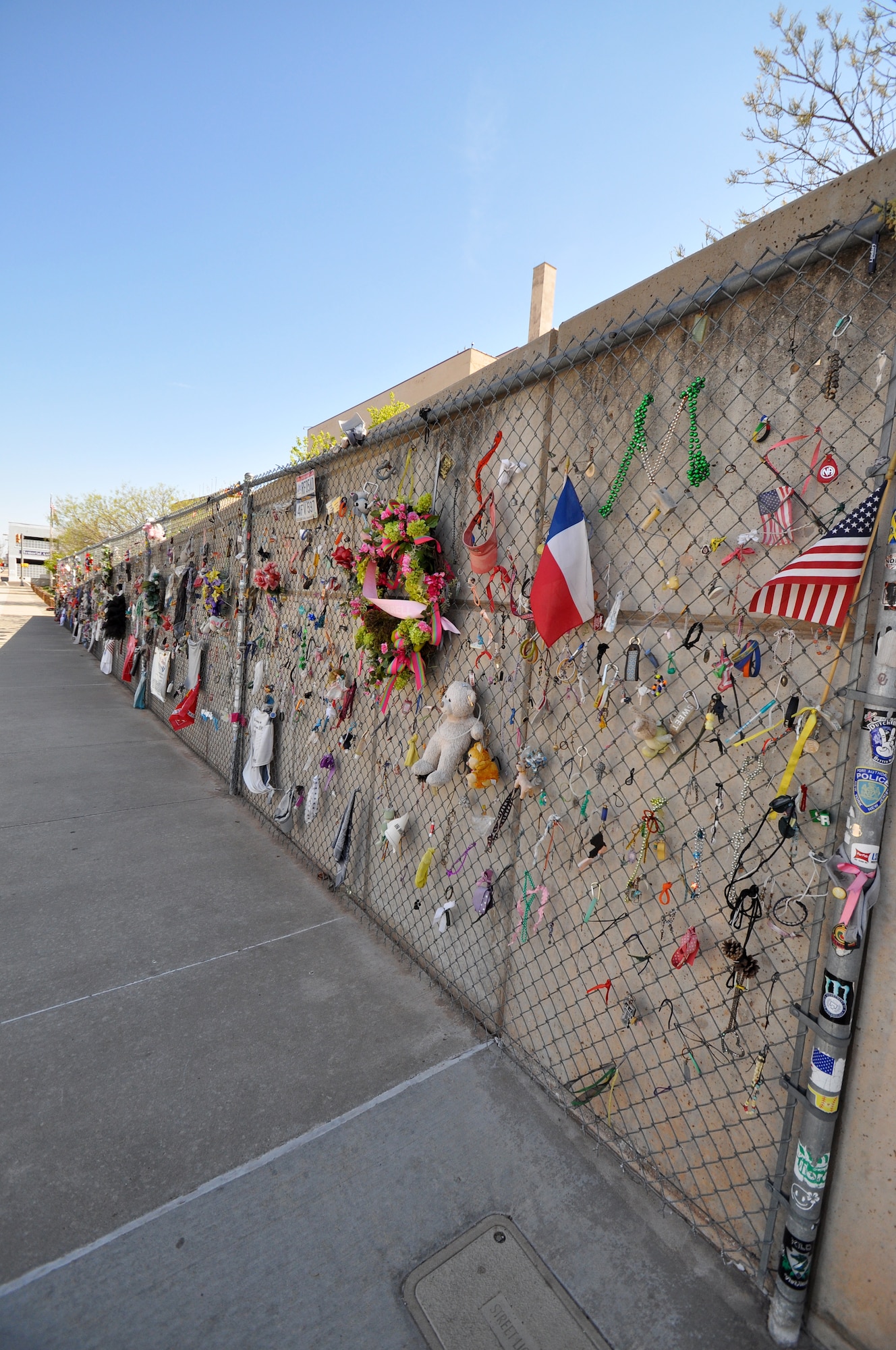Nineteen years after the bombing of the Alfred P. Murrah Federal Building, the symbolic fence is still a place where family, friends, and visitors come to pay respects to those who perished on the morning of April 19, 1995.  The fence was installed to protect the site of the Murrah Building and almost immediately became a place where people began to leave tokens of love and hope.  According the the Oklahoma City National Memorial website, these tokens now total more than 60,000 and are collected and preserved in the museum archives.  More than 200 feet of the original fence stands to give future generations their chance to leave tokens of remembrance.  (U.S. Air Force photo/Senior Airman Mark Hybers)