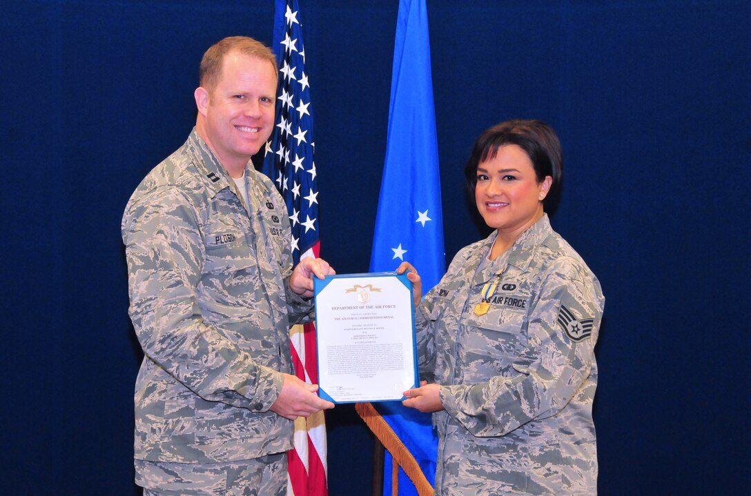 Staff Sergeant Melissa Rocha, flutist with the Air Force Band of the Golden West, receives the Air Force Commendation Medal in a ceremony with band commander Captain Jason Plosch. January, 2014