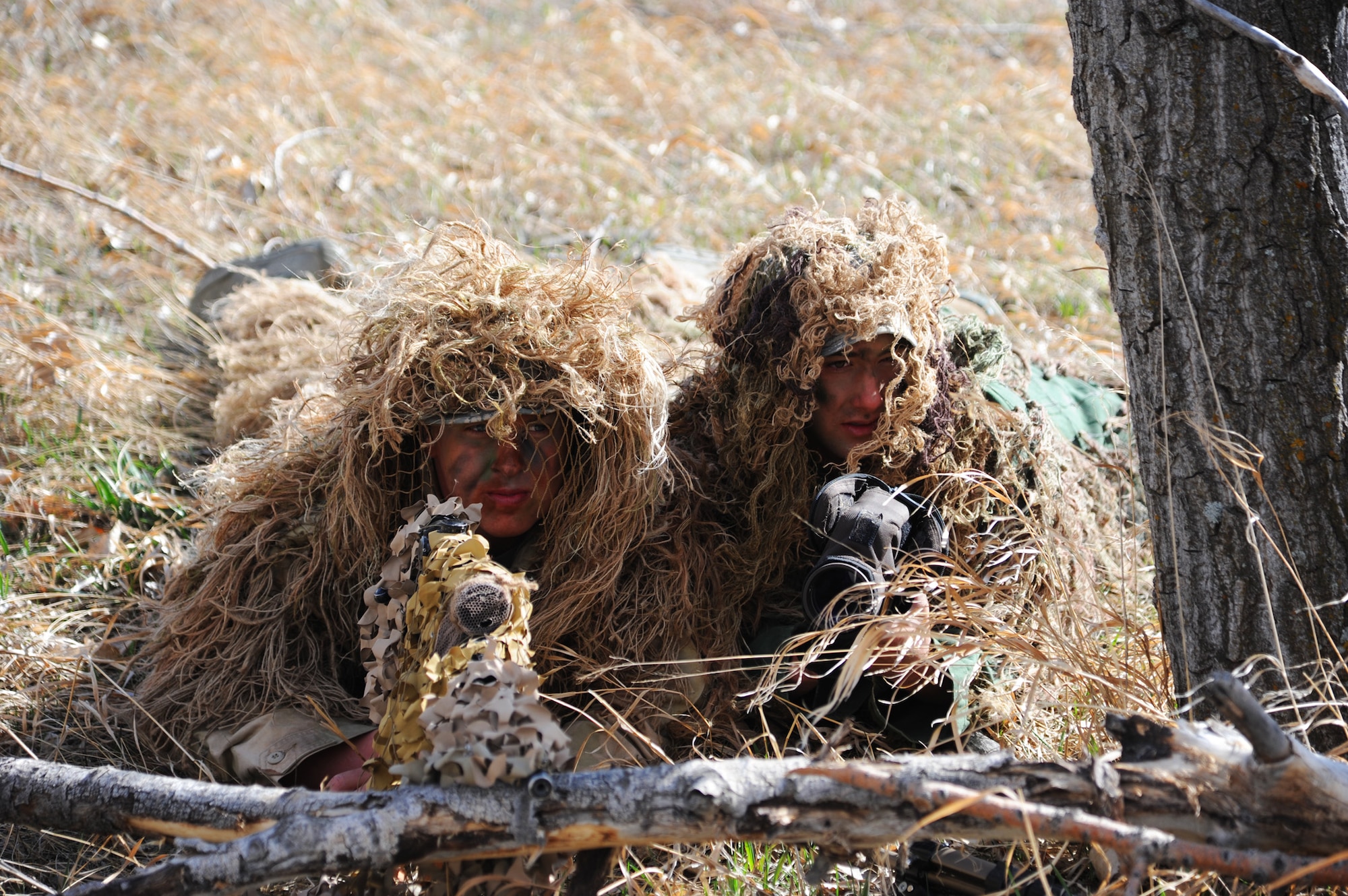 Staff Sgt. Richard Welty, 341st Security Forces Group Tactical Response Force nuclear advanced designated marksman (left), and Senior Airman Isaac Lau, 341st SFG TRF NADM, estimate the range of simulated enemy targets while conducting a training session at Malmstrom’s Warrior Launch Facility on April 11. NADM teams undergo a rigorous six-week training program at Camp Guernsey, Wyo. During the course, members are evaluated on weapons accuracy, camouflage and the ability to sustain themselves in a field environment. (U.S. Air Force photo/Airman 1st Class Joshua Smoot)