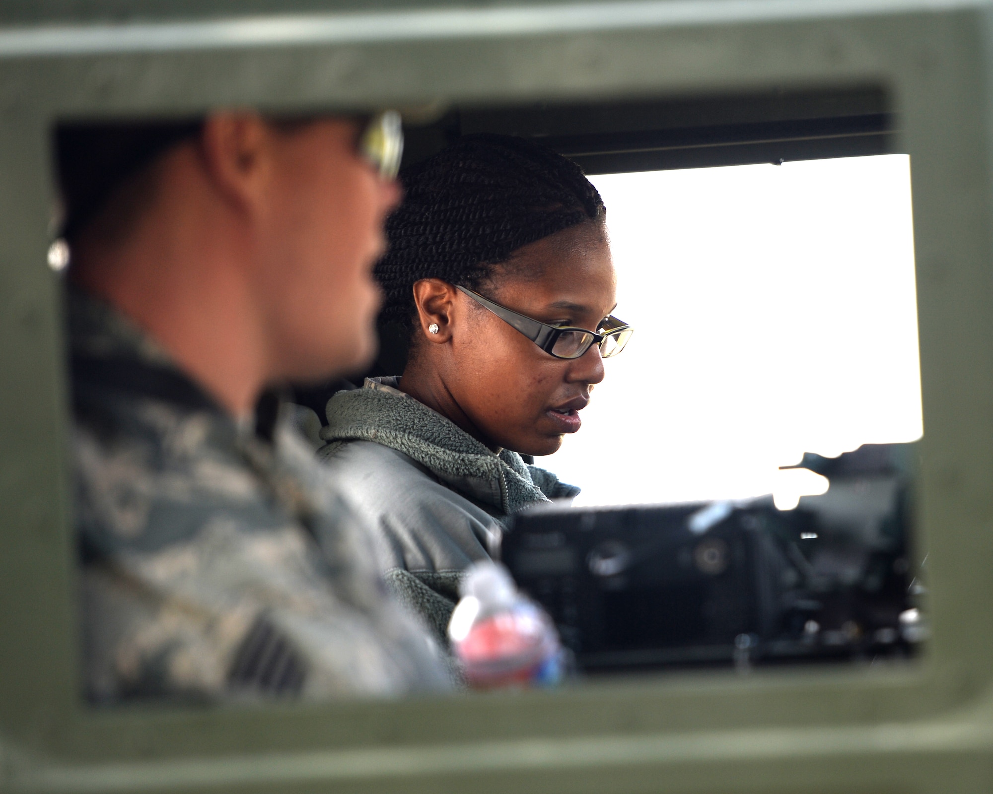 Staff Sgt. Ryan Hogue, the unit training manager with the 147th Air Support Operations Squadron, 147th Reconnaissance Wing, based at Ellington Field in Houston, Texas, trains Staff Sgt. Tyisha McNutt, a human resources assistant from the squadron, on driving a HUMVEE during a field training exercise April 4, 2014, at Camp Swift in Bastrop, Texas. The support personnel participated in the annual exercise to test the requirements necessitated by being members of an ASOS unit.