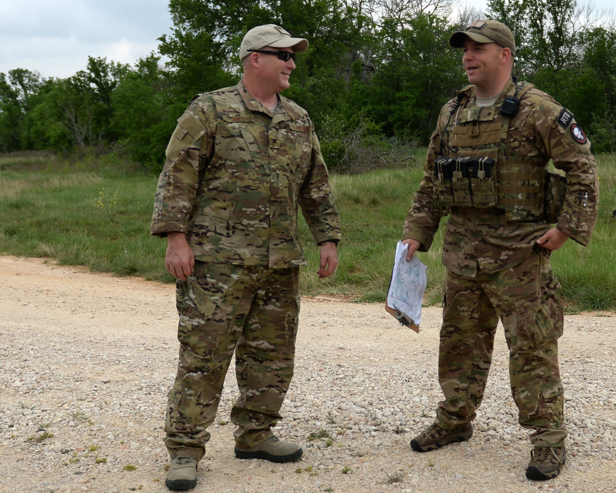 Col. Stan Jones, 147th Operations Group commander, 147th Reconnaissance Wing, based at Ellington Field Joint Reserve Base in Houston, Texas, speaks with a vehicle maintenance non-commissioned officer with the 147th Air Support Operations Squadron during a field training exercise April 3, 2014, at Camp Swift in Bastrop, Texas. The support personnel participated in the annual exercise to test the requirements necessitated by being members of an ASOS unit.
