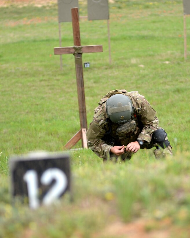 A tactical air control party member with the 147th Air Support Operations Squadron, 147th Reconnaissance Wing, based at Ellington Field Joint Reserve Base in Houston, Texas, reloads an M9 pistol during weapons qualification at the squadron's field training exercise April 3, 2014, at Camp Swift in Bastrop, Texas. The entire squadron traveled to the National Guard base to satisfy training requirements mandated by the career field.