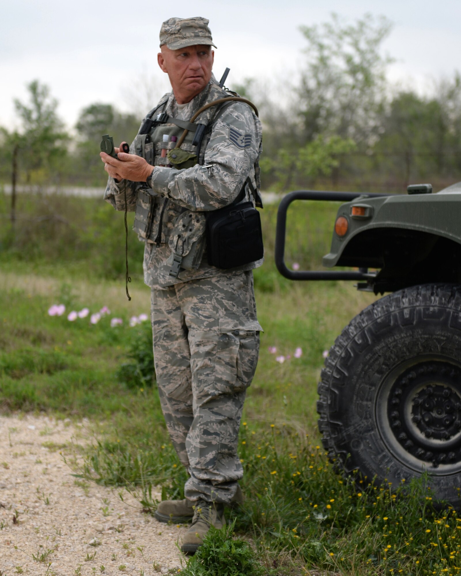A vehicle maintenance airman with the 147th Air Support Operations Squadron, 147th Reconnaissance Wing, based at Ellington Field Joint Reserve Base in Houston, Texas, checks his compass during a field training exercise April 3, 2014, at Camp Swift in Bastrop, Texas. The support personnel participated in the annual exercise to test the requirements necessitated by being members of an ASOS unit.