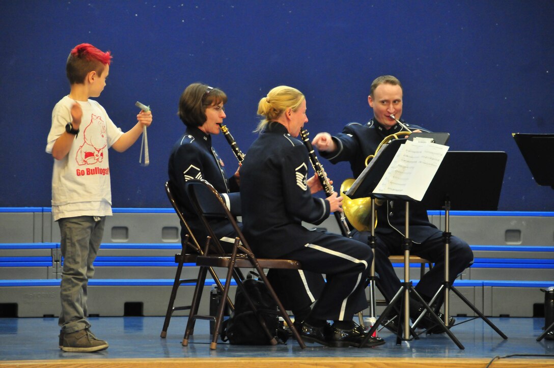 A Suisun City, California, elementary student performs on cue from Staff Sergeant Ed Ochsner, French Horn player for the US Air Force Band of the Golden West. January, 2014
