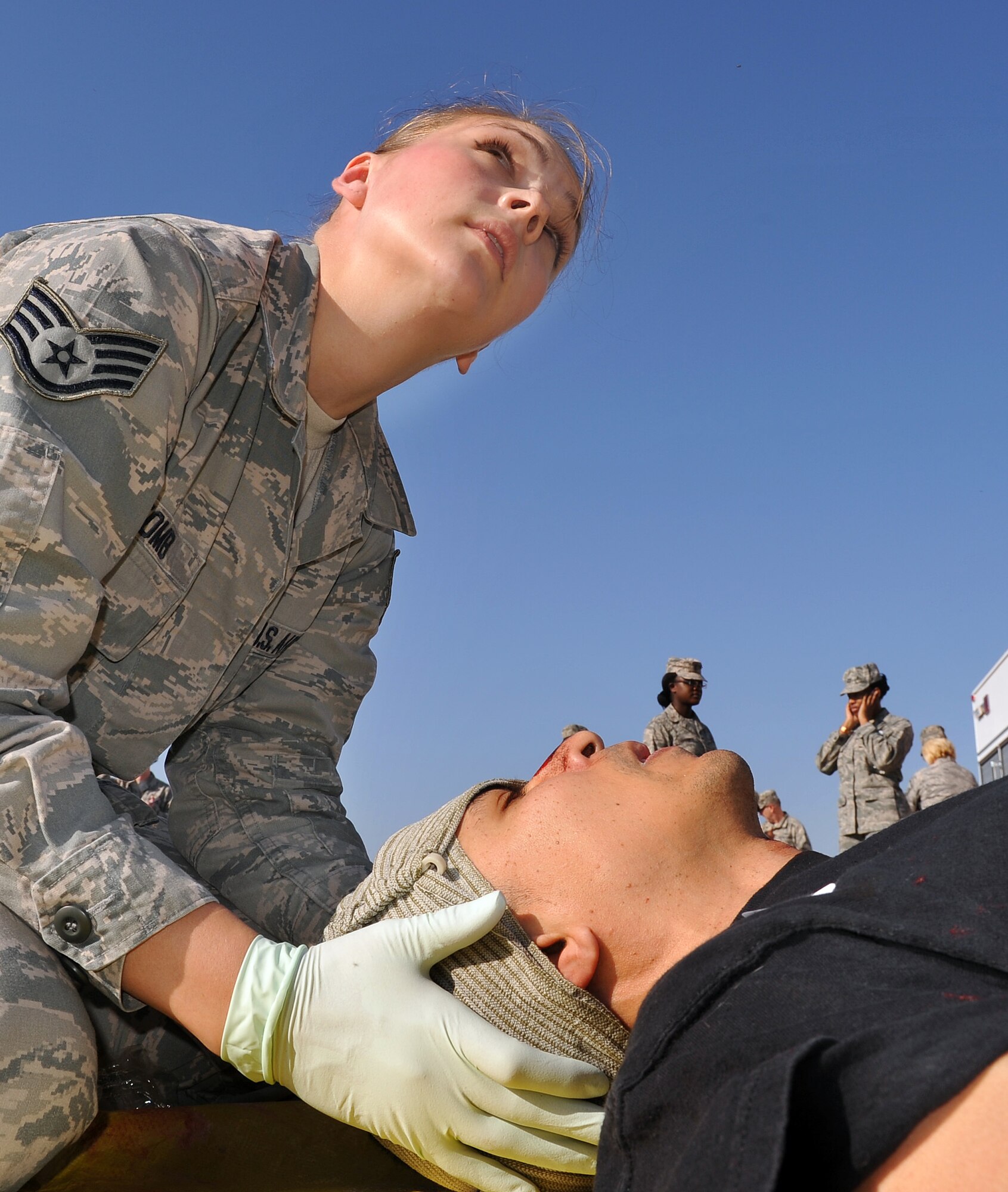 Staff Sgt. Jennifer Tomb, 78th Medical Group medical technician, attends to a crash survivor. As part of the exercise, casualties were promptly evaluated and sorted according to the seriousness of their injuries. (U.S. Air Force photo by Tommie Horton)