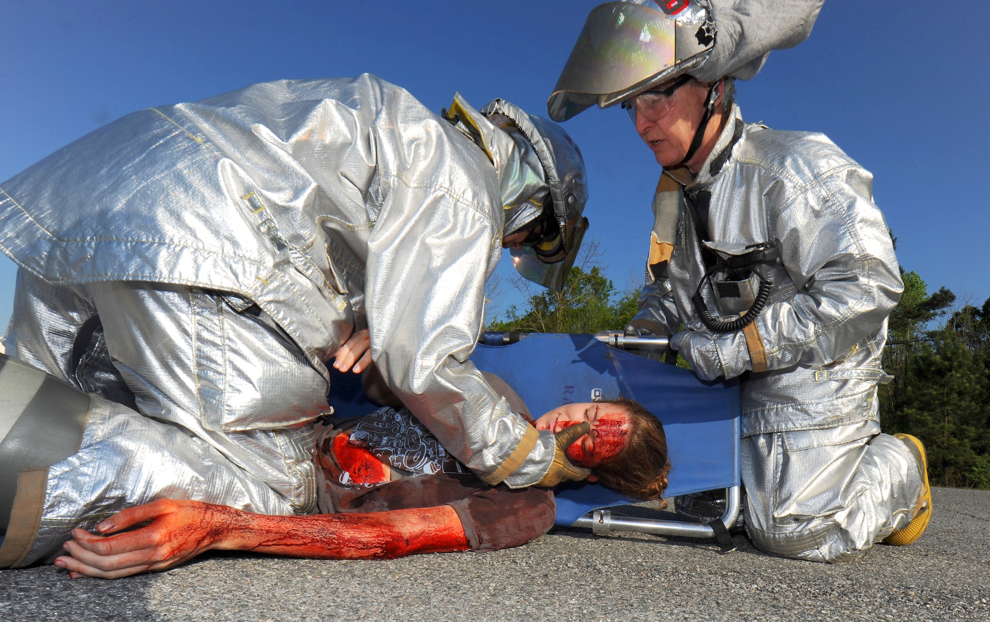 Capt. Greg Watson (left) and Capt. Tony Tabler, Robins Fire Department, recover a mock casualty from a simulated crash site on base April 12. The fire department worked alongside the 78th Medical Group during the joint exercise.(U.S. Air Force photo by Tommie Horton)