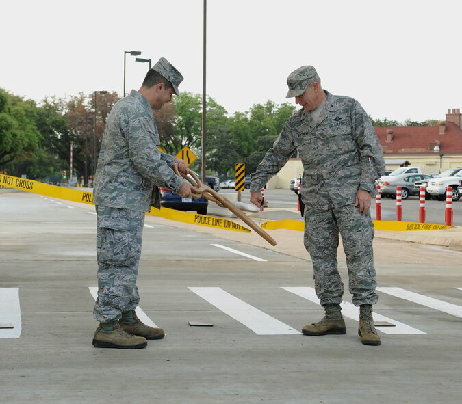 Col. Andrew Gebara, 2nd Bomb Wing commander, left, and Col. Patrick Matthews, 2nd Mission Support Group commander, cut a ribbon signifying the re-opening of the North Gate on Barksdale Air Force Base, La., April 18, 2014. The North Gate?s hours of operation will be from 5:30 a.m. to 9 p.m. (U.S. Air Force photo/Senior Airman Benjamin Gonsier)