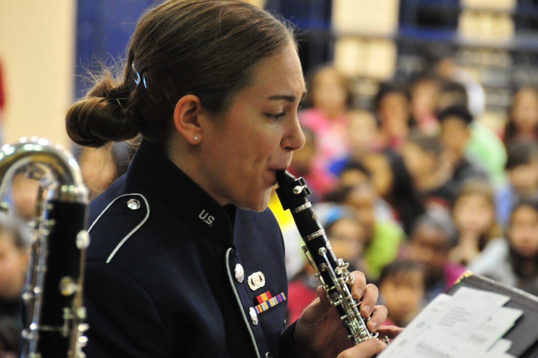 Airman First Class Alaina Pritz, clarinetist with the Air Force Band of the Golden West's "Wild West Winds" clarinet quartet, performs for a gymnasium full of Suisun City, CA elementary students in January, 2014