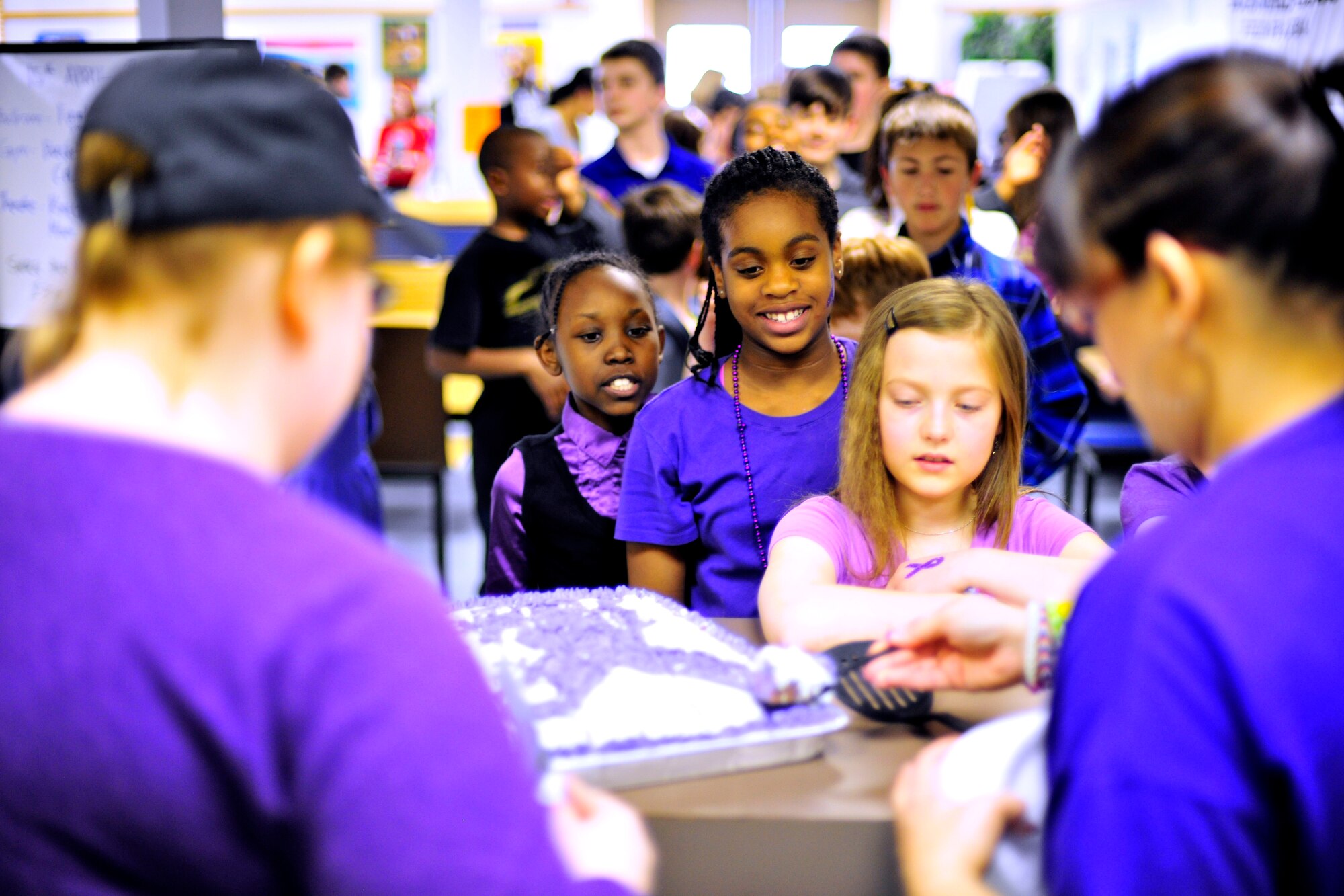 Military children line up to receive purple cupcakes at the youth center during Purple Up! for military kids Day April 15, 2014, Eielson Air Force Base, Alaska. Purple Up Day shows appreciation and understanding for military children and their unconditional support to their military parents.  (U.S. Air Force photo by Staff Sgt. Jim Araos)