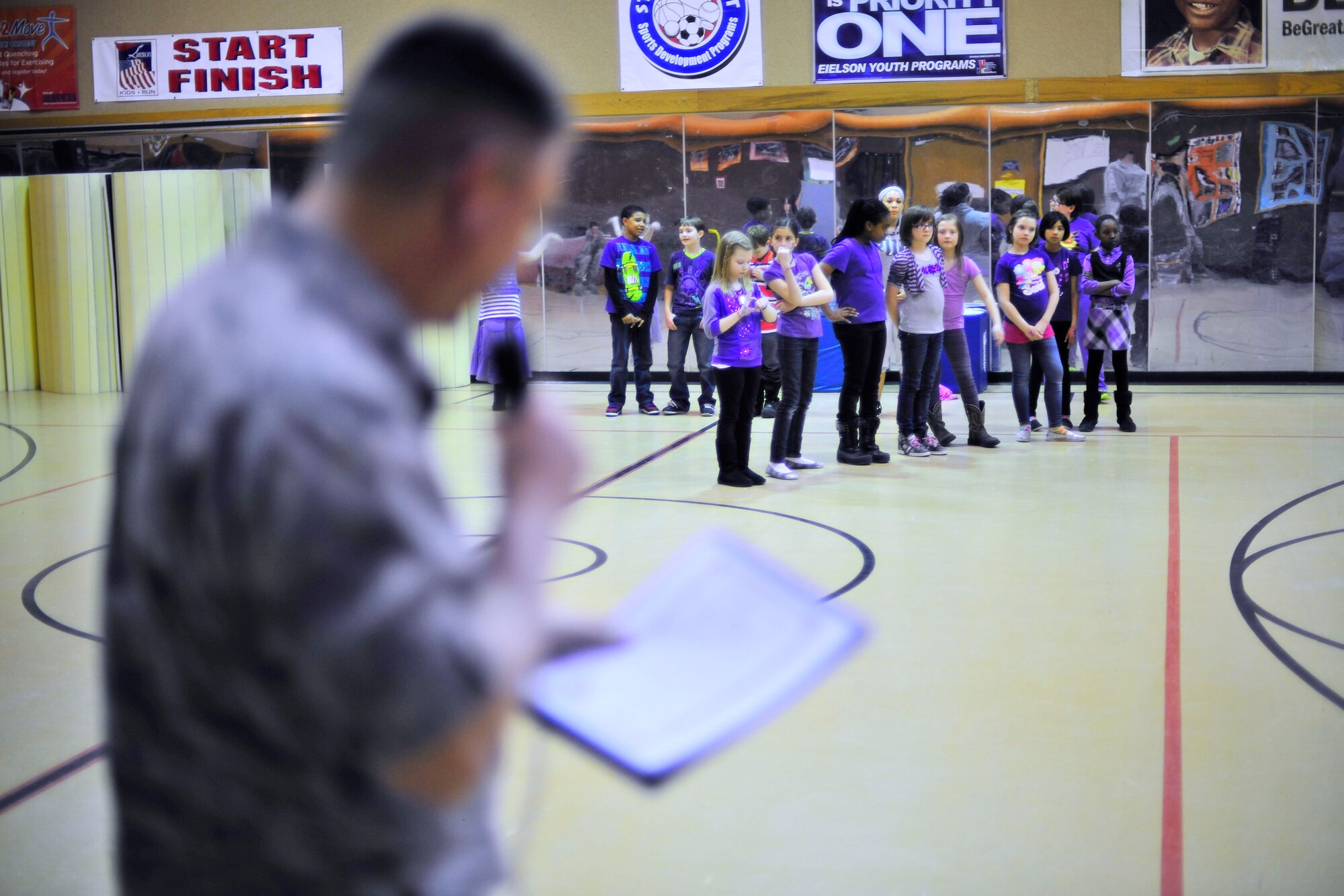 U.S. Air Force Col. Larry Rice, 354th Mission Support Group commander, reads the Purple Up! proclamation during Purple Up! for military kids Day April 15, 2014, Eielson Air Force Base, Alaska.  Purple Up Day pays tribute to military children for incredible resilience in support of their military parents. (U.S. Air Force photo by Staff Sgt. Jim Araos)