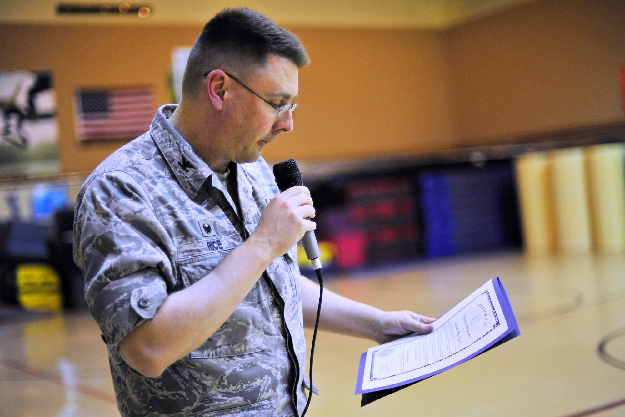 U.S. Air Force Col. Larry Rice, 354th Mission Support Group commander, reads the Purple Up! proclamation during Purple Up! for military kids Day April 15, 2014, Eielson Air Force Base, Alaska. The proclamation was written by Gov. Sean Parnell, placing emphasis on the special courage, strength and sacrifice of military children.  (U.S. Air Force photo by Staff Sgt. Jim Araos)