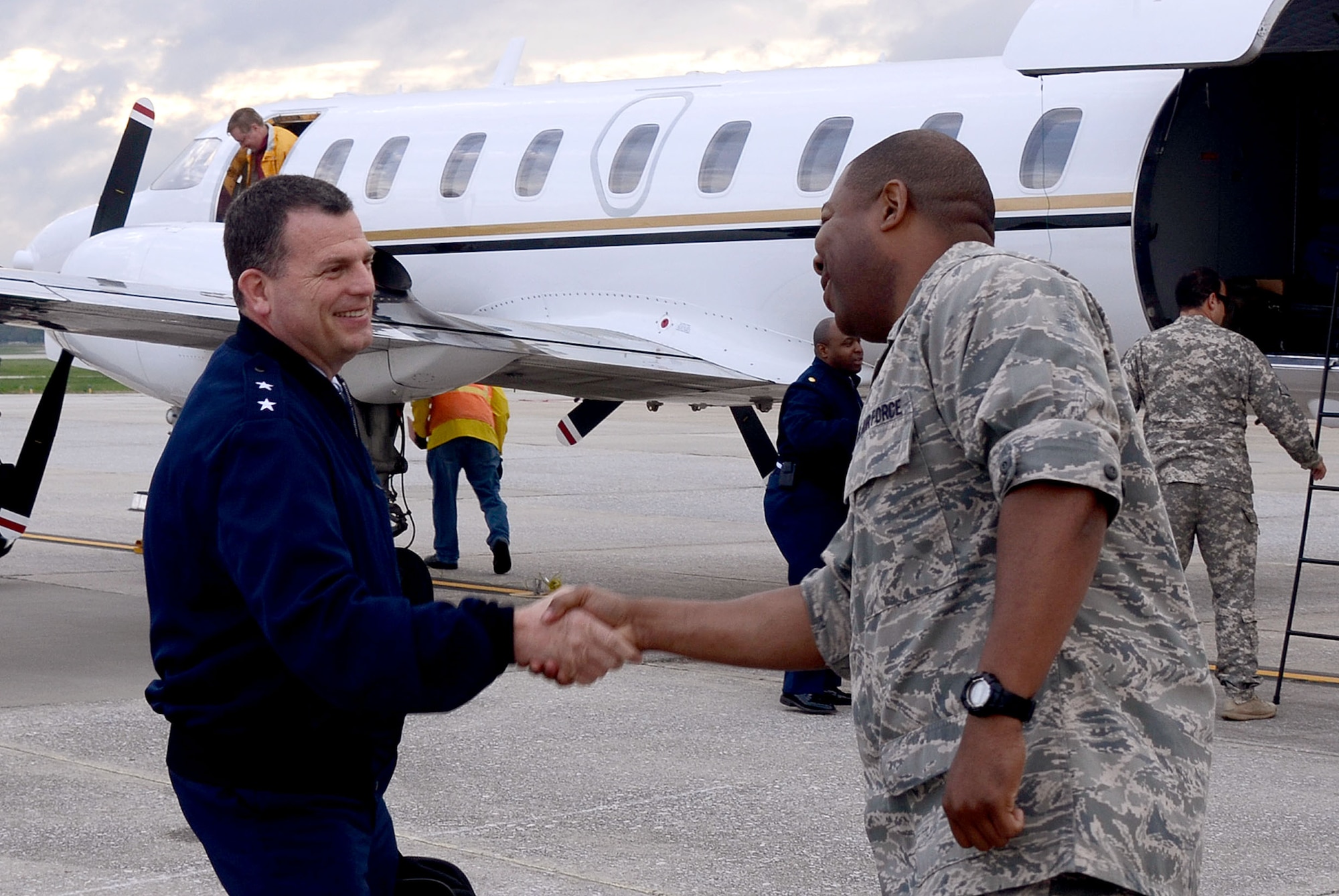 Maj. Quincy D. Hudson, 94th Airlift Wing protocol officer, welcomes Maj. Gen. Dwyer L. Dennis, Program Executive Officer for Fighters and Bombers, Air Force Life Cycle Management Center (AFLCMC), Air Force Materiel Command, Wright-Patterson Air Force Base, Ohio as he and his team of Wing Commanders lands at Dobbins Air Reserve Base, Ga. April 14 for an offsite conference.  Dennis and his team are met by Hudson and Col. Marshall S. Irvin Jr., 94th Mission Support Group, commander. (U.S. Air Force photo/Don Peek)
