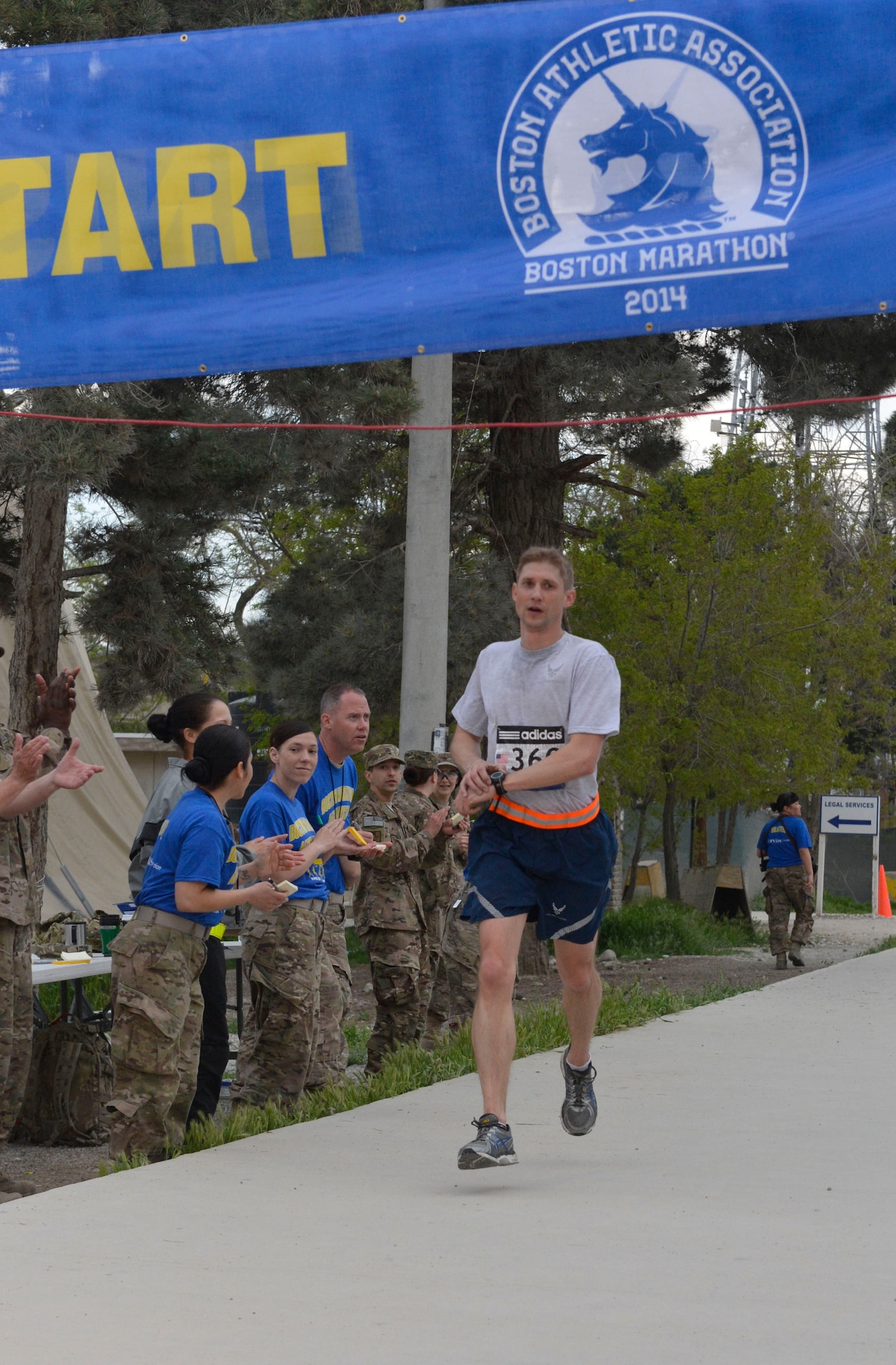 U.S. Air Force Capt. Scott Adams, deployed from the Air Force Legal Operations Agency in Atlanta, Ga., and running in his ninth marathon, crosses the finish line with a time of 2:51:43 in the Boston Marathon Shadow Run-Afghanistan 2014 at Bagram Airfield, Afghanistan, April 18, 2014. Adams took first place among all of the Air Force runners.(U.S. Air Force photo by Senior Master Sgt. Gary J. Rihn/Released) 