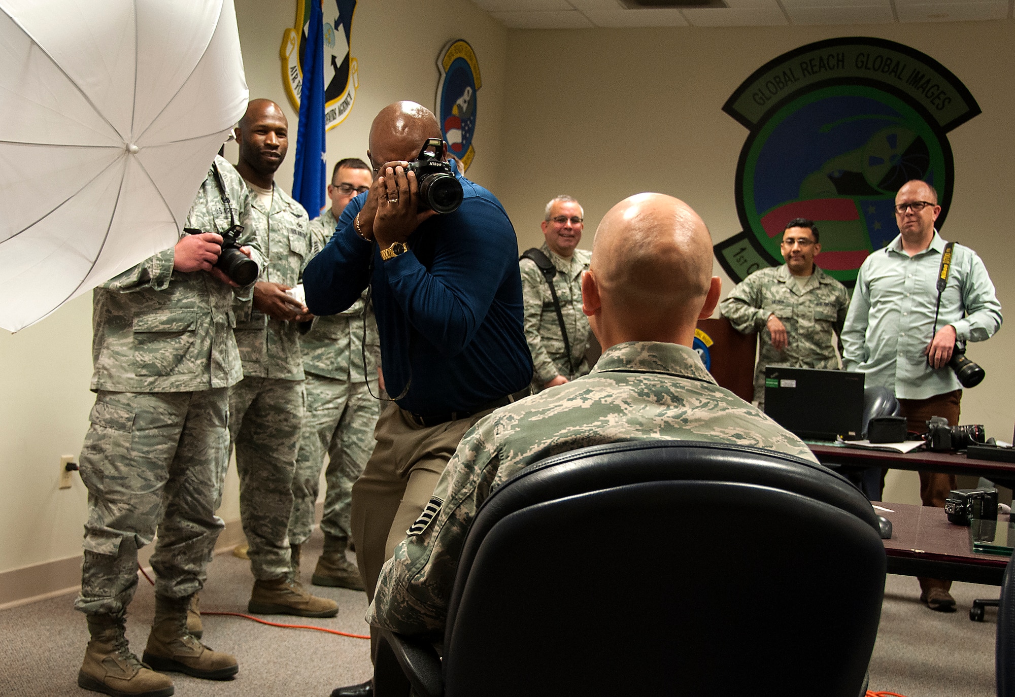 Clarence Brown,1st CCS’s chief of Still Photo Standardization, demonstrates proper photo technique to Reserve public affairs specialist during a 3 days crash course photo training session coordinated by  315th Airlift Wing Public Affairs this week. About 23 Air Force Reserve public affairs specialists from bases across the country showed up at Joint Base Charleston with an eagerness to improve their photo skills under the tutelage of some of the Air Force’s most elite photographers – 1st Combat Camera Squadron. (U.S. Air Force Reserve photo by Michael Dukes)