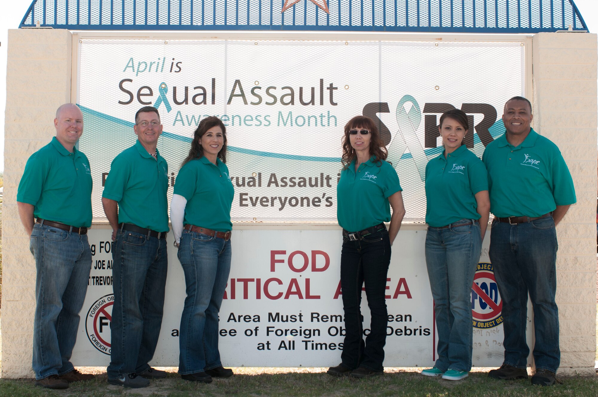 The 162nd Wing Sexual Assault Prevention and Response team dressed in jeans and teal shirts for Denim Day 2014, being honored April 18 here at the wing. The team members are, from left to right: Maj. Stephen Moorhead, Sexual Assault Response Coordinator, Master Sgt. Brent Thompson, victim advocate, Master Sgt. Marnie Jewell-Johnson, victim advocate, Tech. Sgt. Mitzi Eggers, victim advocate, 1st Lt. Melissa Gonzalez, SARC, Master Sgt. Gary Jack, victim advocate. (U.S. Air National Guard photo by Tech. Sgt. Hollie Hansen/Released)