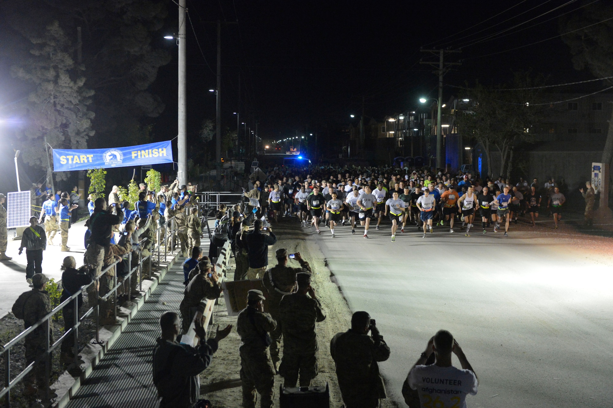 Runners take off from the starting line at the Boston Marathon Shadow Run-Afghanistan 2014 at Bagram Airfield, Afghanistan, April 18, 2014. Over 600 runners participated in the race.(U.S. Air Force photo by Senior Master Sgt. Gary J. Rihn/Released)