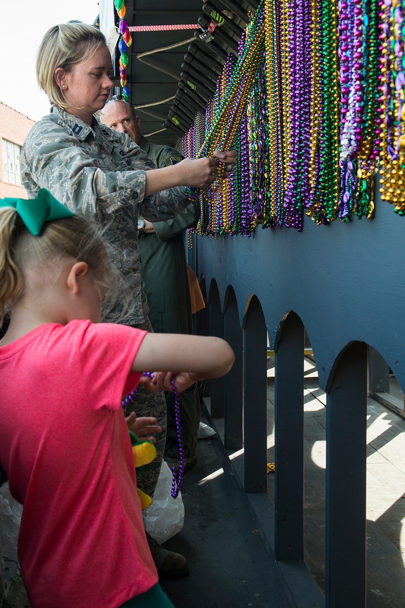 U.S. Air Force Capt. Stephanie Kennedy a her daughter Haley prepare their float for the start of the Holiday in Dixie parade, April 12, 2014, Shreveport, La. Members of the 307th Bomb Wing manned the "Salute to Military" float and threw beads to people along the parade route. (U.S. Air Force photo by Master Sgt. Greg Steele/Released)
