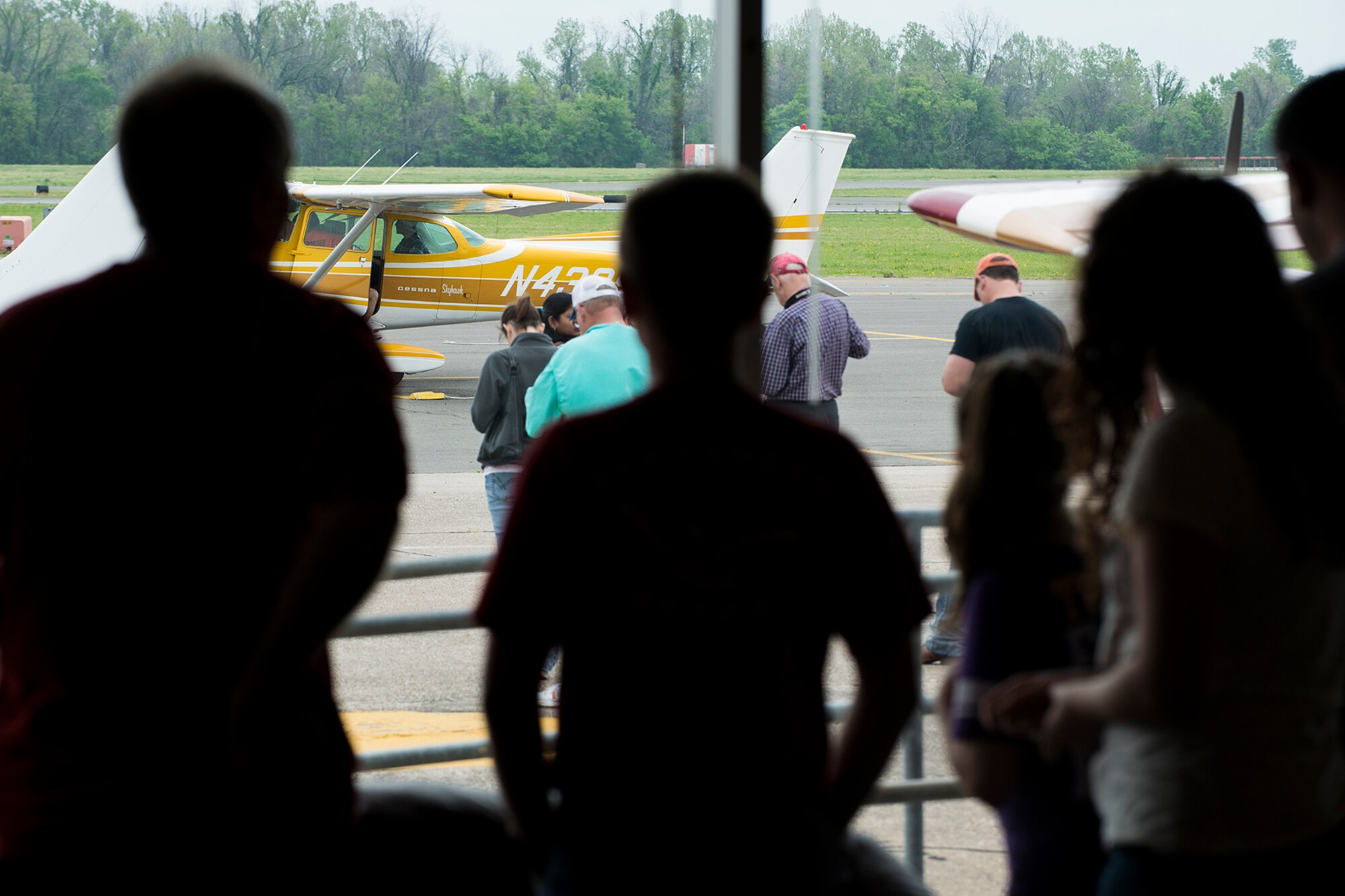 Kids wait for their turn to fly during an event held at the Shreveport Downtown Airport, April 12, 2014, Shreveport, La. Pilots volunteered their time, airplanes and gas to support the 343rd Experimental Aircraft Association by offering free flights for kids ages 8-18. (U.S. Air Force photo by Master Sgt. Greg Steele/Released)