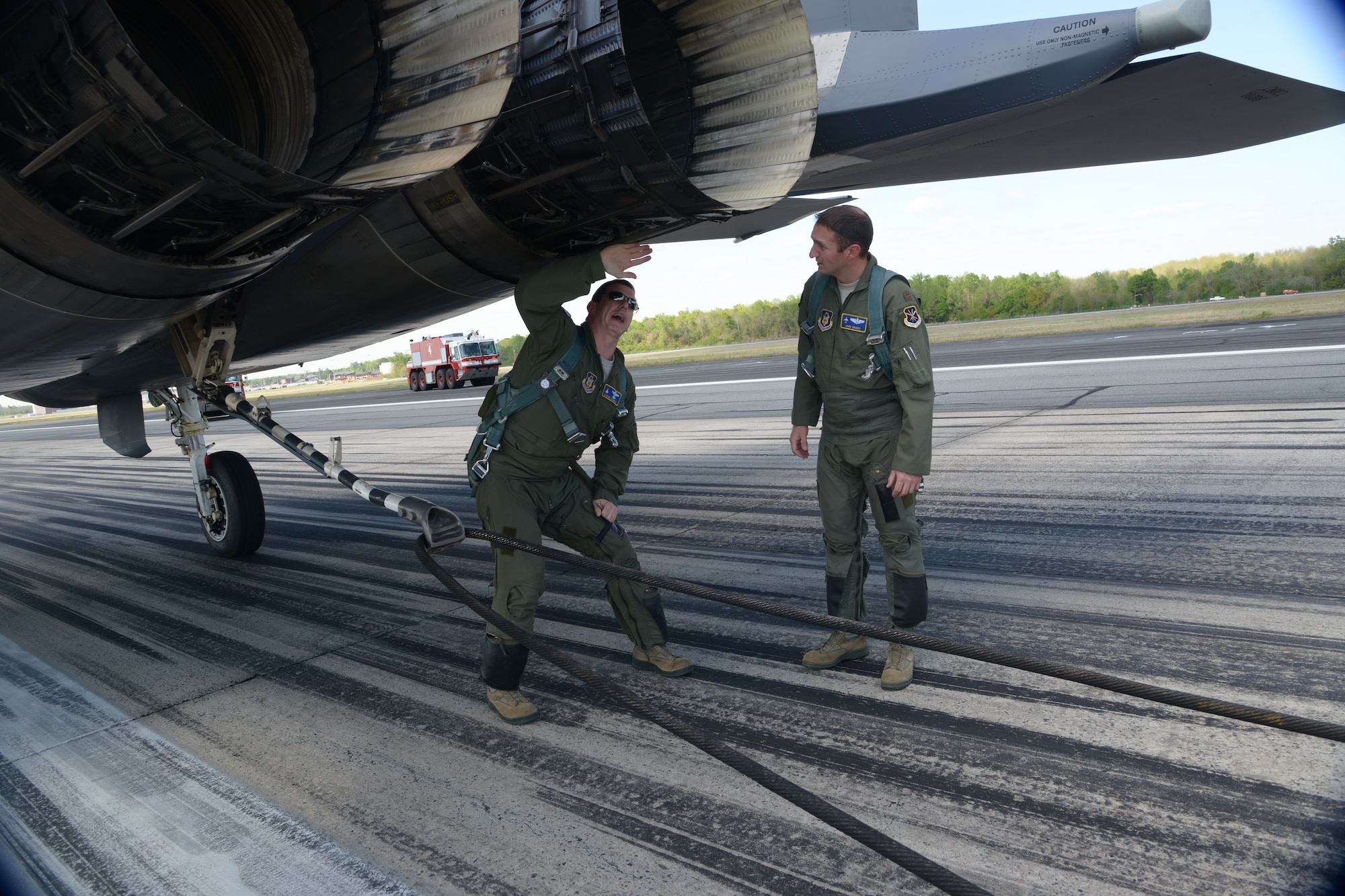 Pilots Lt. Col. Stephen D’Amico, F-15 flight commander, and Maj. John Grady, C-5 flight commander, inspect the F-15E following the use of Robins’ aircraft barrier arresting system, April 8, 2014. (U.S. Air Force photo by Ray Crayton)