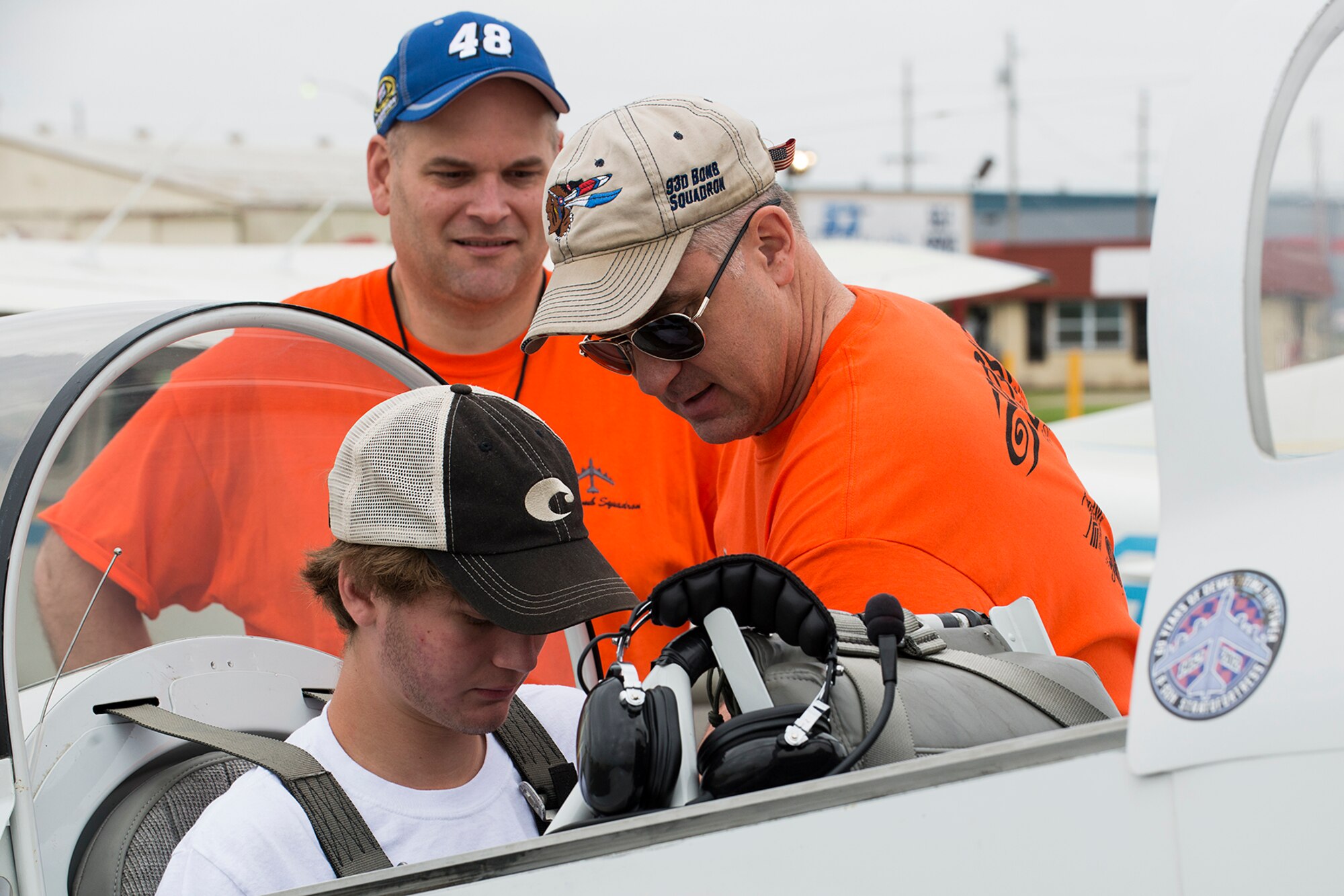 U.S. Air Force Col. David Leedom helps strap in a first-time flyer at the Shreveport Downtown Airport, April 12, 2014, Shreveport, La. Leedom volunteered his time and airplance to fly kids ages 8-18 during a Young Ealges Program event hosted by the 343rd Experimental Aircraft Association. (U.S. Air Force photo by Master Sgt. Greg Steele/Released)