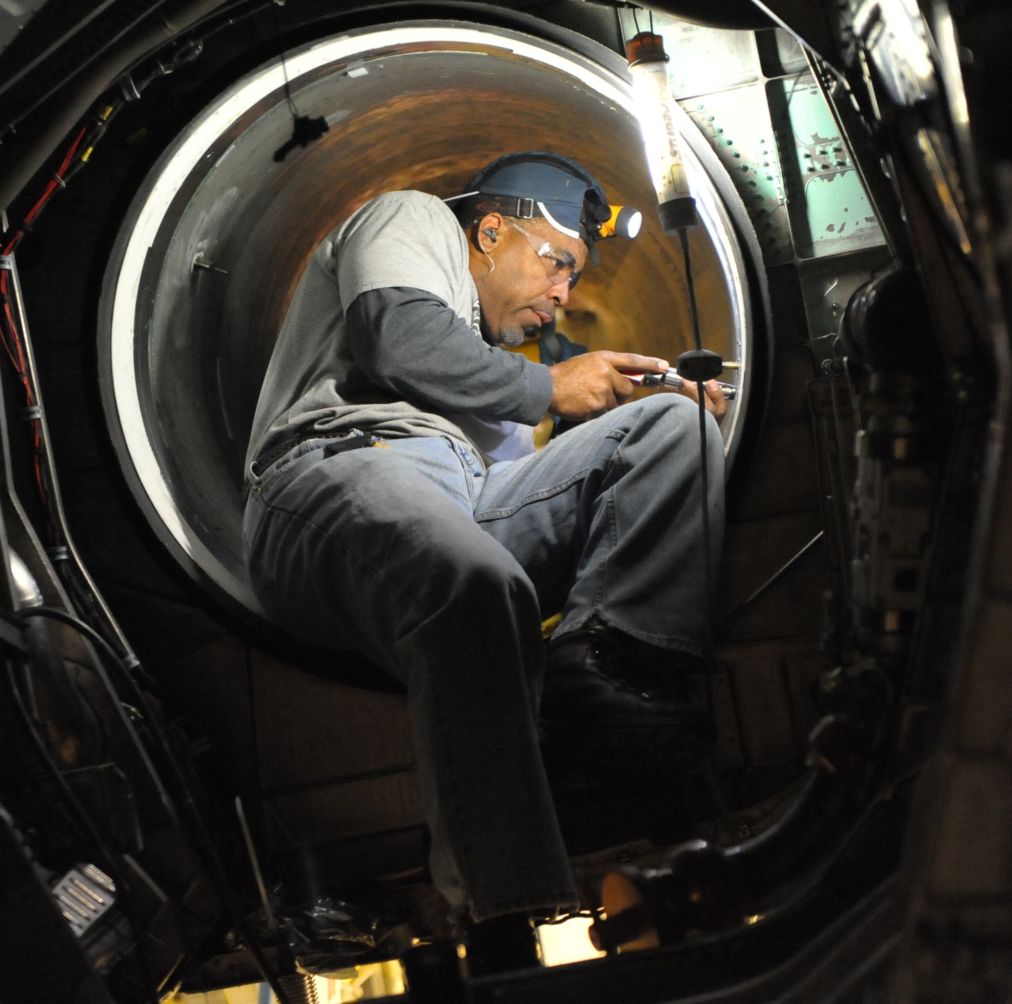 Anthony Farrow, 561st Aircraft Maintenance Squadron Production Support, changes intake fasteners on an F-15. (U.S. Air Force photo by Ray Crayton)