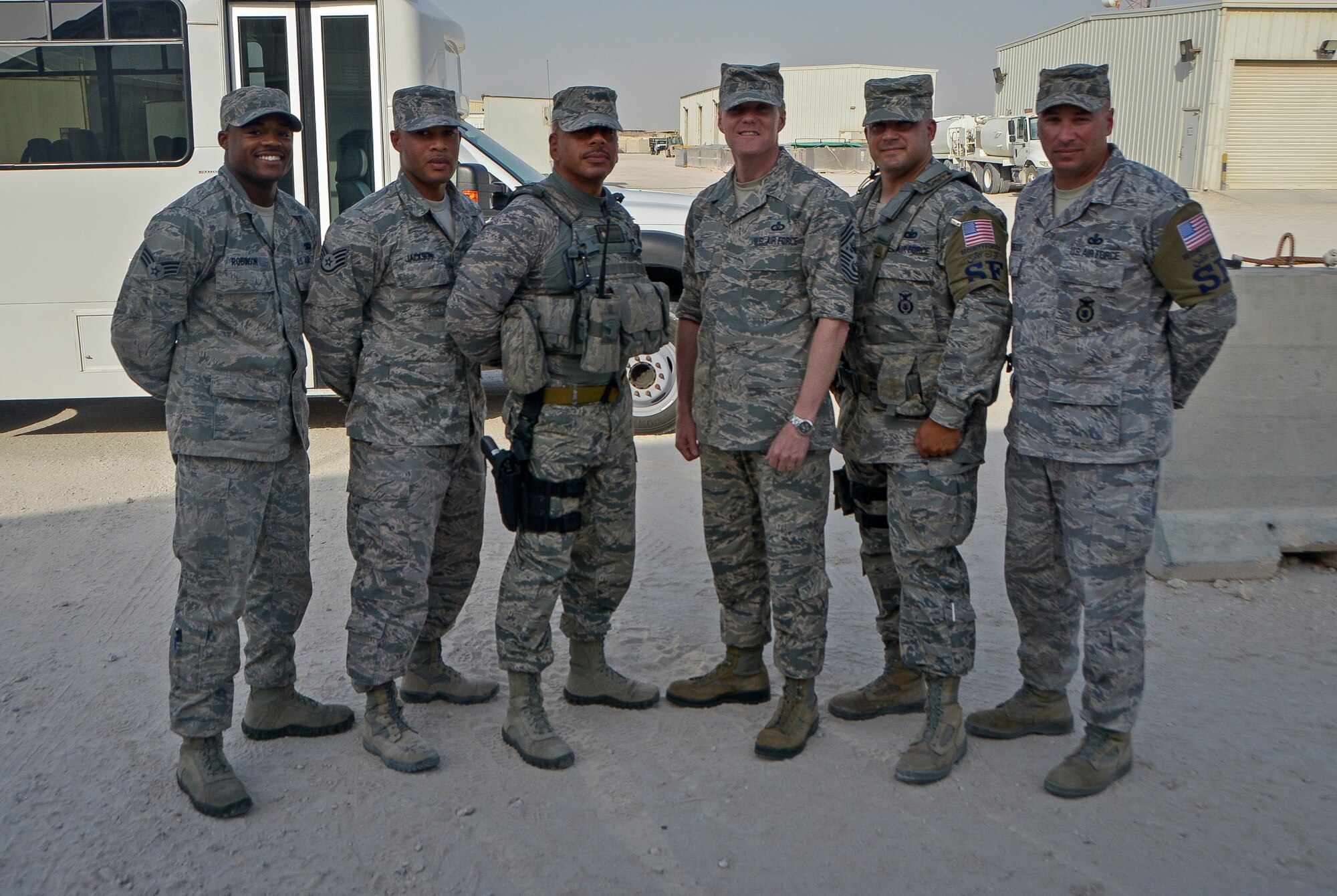 Chief Master Sgt. of the Air Force James A. Cody smiles with Defenders from the 379th Expeditionary Security Forces Squadron at Al Udeid Air Base, Qatar, April 17, 2014. Cody toured the base to learn about the mission, capabilities and the way of life of the Airmen of the 379th Air Expeditionary Wing. During an all call, Cody shared his insights with Airmen about the service’s ongoing force management programs, the direction the service is headed in and the importance of air superiority. (U.S. Air Force photo/Senior Airman Jared Trimarchi)