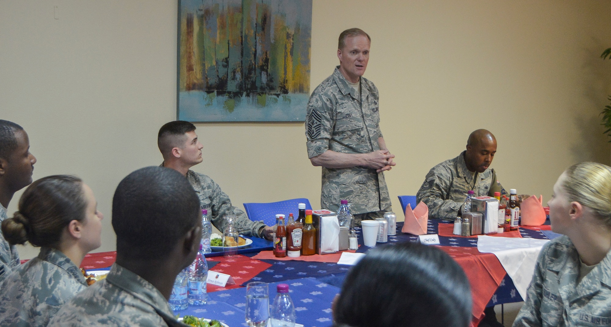 Chief Master Sgt. of the Air Force James A. Cody discusses daily life with a group of Airmen during lunch at Al Udeid Air Base, Qatar, April 17, 2014. Cody toured the base to learn about the mission, capabilities and the way of life of the Airmen of the 379th Air Expeditionary Wing. During an all call, Cody shared his insights with Airmen about the service’s ongoing force management programs, the direction the service is headed in and the importance of air superiority. (U.S. Air Force photo/Senior Airman Jared Trimarchi)