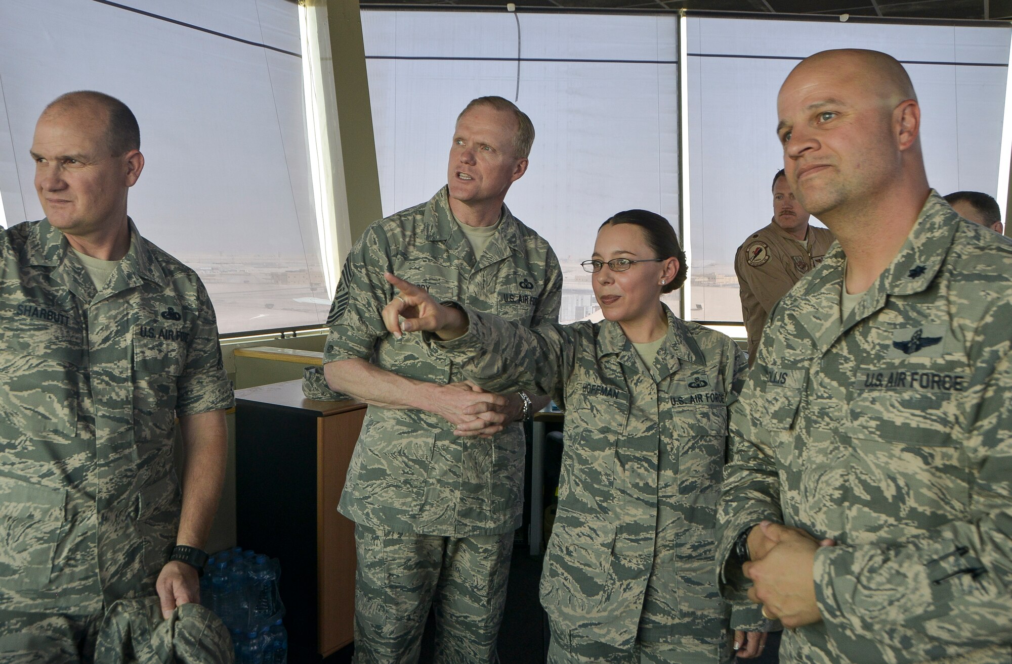 Master Sgt. Carla Hoffman, tower chief controller for the 379th Expeditionary Operations Support Squadron, shows Chief Master Sgt. of the Air Force James A. Cody the flight line in the Air Traffic Control Tower at Al Udeid Air Base, Qatar, April 17, 2014. Cody toured the base to learn about the mission, capabilities and the way of life of the Airmen of the 379th Air Expeditionary Wing. During an all call, Cody shared his insights with Airmen about the service’s ongoing force management programs, the direction the service is headed in and the importance of air superiority. Hoffman is deployed from Ramstein Air Base, Germany and a native of Albuquerque, N.M.  (U.S. Air Force photo/Senior Airman Jared Trimarchi)