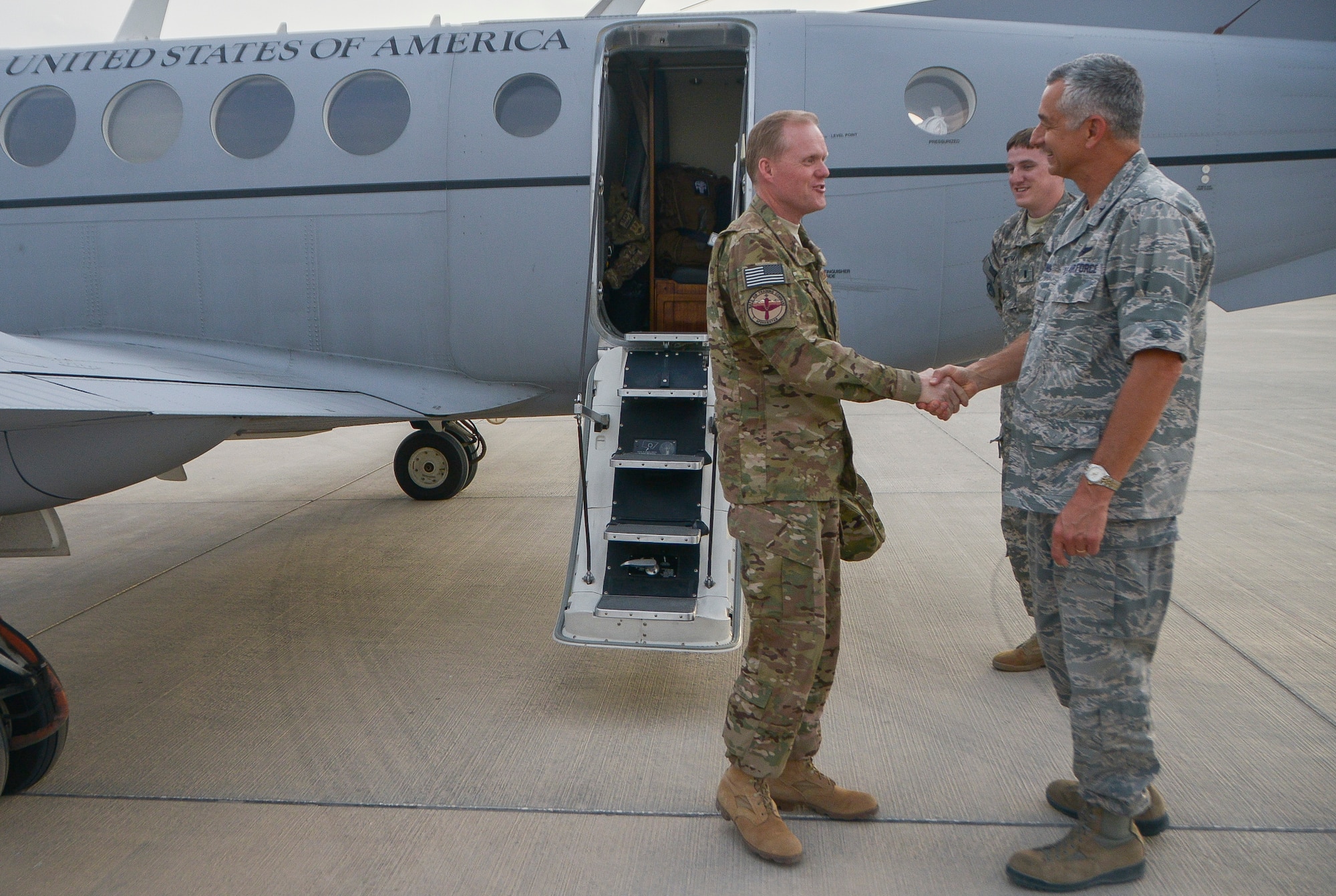 Brig. Gen. Roger H. Watkins greets Chief Master Sgt. of the Air Force James A. Cody at Al Udeid Air Base, Qatar, April 16, 2014. Cody toured the base to learn about the mission, capabilities and the way of life of the Airmen of the 379th Air Expeditionary Wing. During an all call, Cody shared his insights with Airmen about the service’s ongoing force management programs, the direction the service is headed in and the importance of air superiority. Watkins is the 379th AEW commander who hails from Fort Worth, Texas, and is stationed here. (U.S. Air Force photo/Senior Airman Jared Trimarchi)