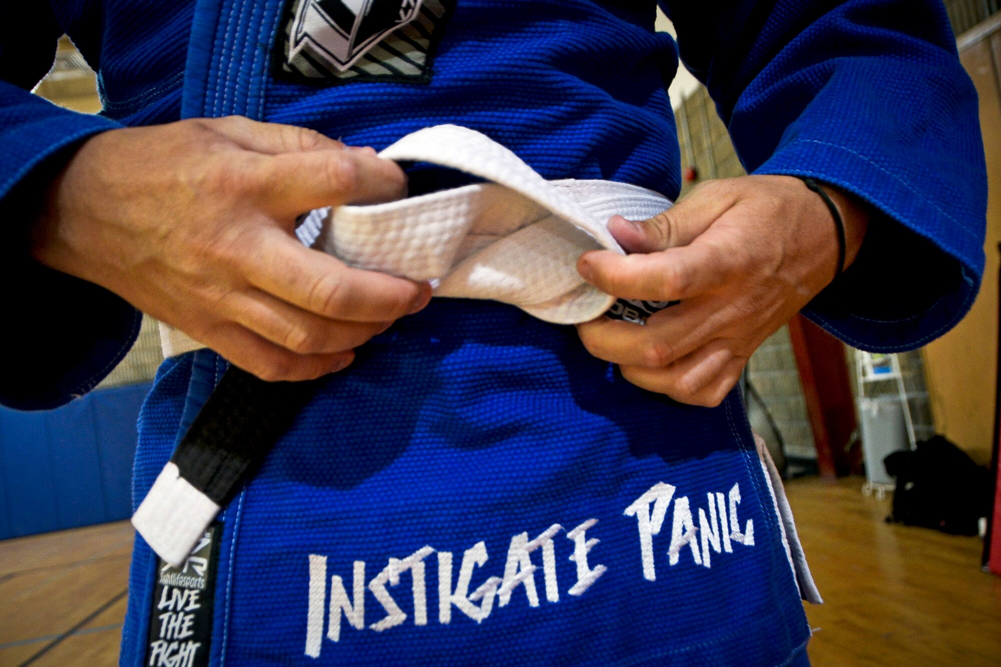 Master Sgt. Justin Klassen ties his belt during a Brazilian Jiu-Jitsu class at Al Udied Air Base, Qatar, April 15, 2014. The AUAB Brazilian Jiu-Jitsu Club is led by four instructors who teach an art form which requires commitment, dedication and a close attention to detail, which are all familiar traits of being in the military. (U.S. Air Force photo/Senior Airman Jared Trimarchi) 