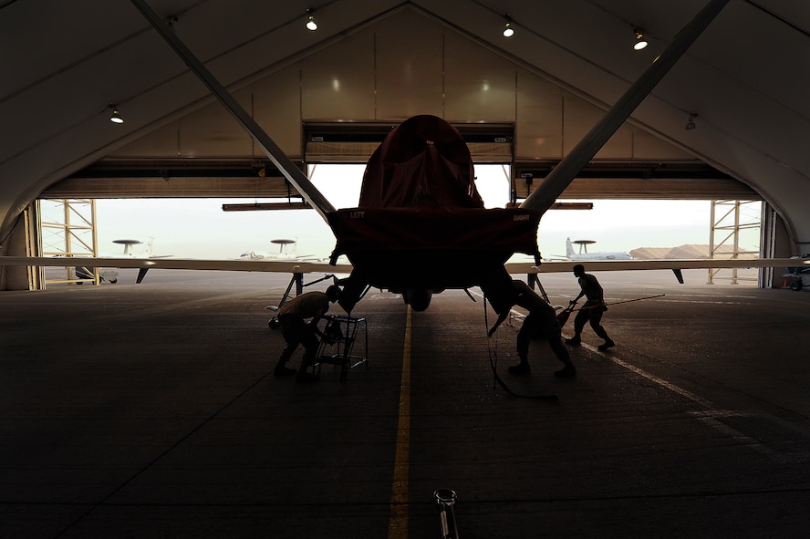 Airmen from the 380th Expeditionary Aircraft Maintenance Squadron prepare an RQ-4 Global Hawk for a flight April 15, 2014, at an undisclosed location in Southwest Asia. The Global Hawk is an unmanned aircraft that provides intelligence, surveillance, reconnaissance and communications capabilities over Southwest Asia. (U.S. Air Force photo by Tech. Sgt. Russ Scalf/Released)
