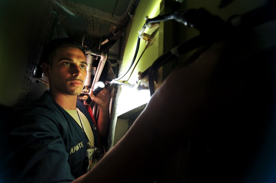 Senior Airman Blaine Aponte, a 380th Expeditionary Aircraft Maintenance Squadron assistant dedicated crew chief, inspects inside the wheel well of an RQ-4 Global Hawk April 15, 2014, at an undisclosed location in Southwest Asia. Aponte, a Naples, Fla., native, is deployed from Beale Air Force Base, Calif.  (U.S. Air Force photo by Tech. Sgt. Russ Scalf/Released)