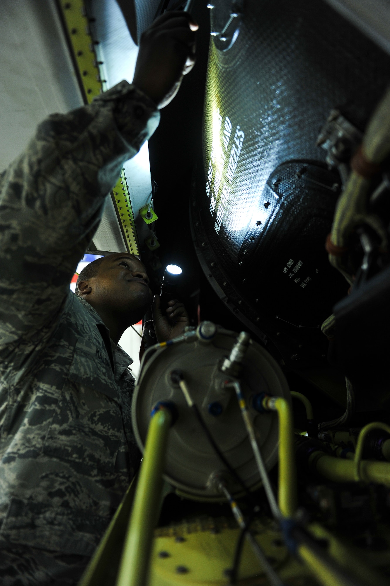 Staff Sgt. Jahmal Maloney, a 380th Expeditionary Aircraft Maintenance Squadron dedicated crew chief, inspects the hydraulic reservoir of an RQ-4 Global Hawk prior to a flight April 15, 2014, at an undisclosed location in Southwest Asia. The reservoir ensures all of the hydraulic components on the aircraft are properly functioning during flight. Maloney, a New Port, R.I., native, is deployed from Beale Air Force Base, Calif. (U.S. Air Force photo by Tech. Sgt. Russ Scalf/Released)