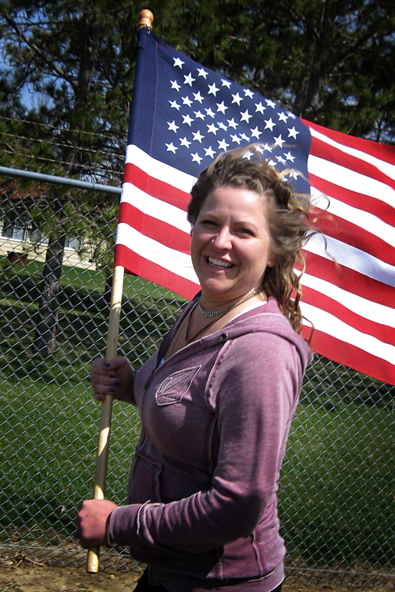Erin Strickland, 434th Air Refueling Wing accounting liaison officer, runs with the American Flag during an Easter Egg run held April 17, 2014 at Grissom Air Reserve Base, Ind. The run was held along a 5K course and designed to develop unity through exercise and fun. (U.S. Air Force photo/Tech. Sgt. Douglas Hays)