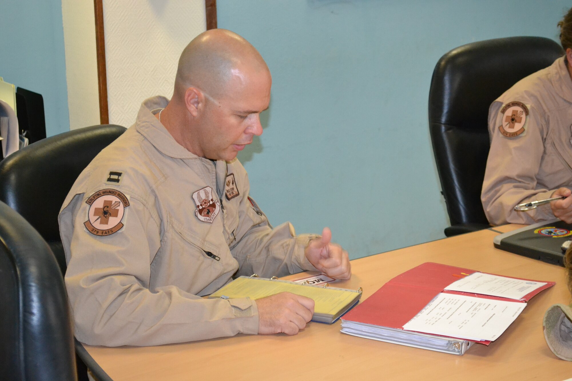Capt David Steiner, a nurse with the 379th Expeditionary Aeromedical Evacuation Squadron, reads through crew checklists and standard operating procedures prior to an AE mission in support of Operation Enduring Freedom, April 16, 2014, Al Udeid Air Base, Qatar.  A crew of two nurses and three medical technicians prepare to transport three patients with minor medical conditions and assign specific tasks pertaining to cardiac arrest procedures, C-130 Hercules configuration, and egress procedures and aircraft emergencies. (U.S. Air Force photo by Maj. Nicole David) 

