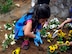 Bea Lyn Villa Garcia, 7, daughter of Master Sgt. Michael Scott, 51st Security Forces Squadron flight chief, digs a hole for a flower during the Arbor Day Tree Planting event April 17, 2014 at Osan Air Base, Republic of Korea. The students planted 10 evergreen trees and 200 flowers. (U.S. Air Force photo by Senior Airman David Owsianka)
