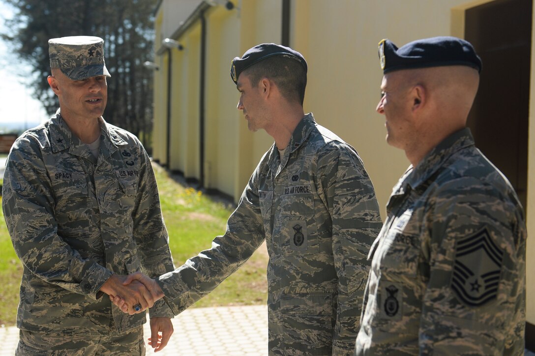 U.S. Air Force Brig. Gen. Bradley Spacy, United States Air Forces in Europe and Air Forces Africa director of logistics, installations and missions support, is greeted by members of the 52nd Security Forces Squadron outside the new Combat Arms Training and Maintenance facility during his visit April 16, 2014, at Spangdahlem Air Base, Germany. During his visit the general met with 52nd Mission Support Group Airmen. (U.S. Air Force photo by Senior Airman Rusty Frank/Released)