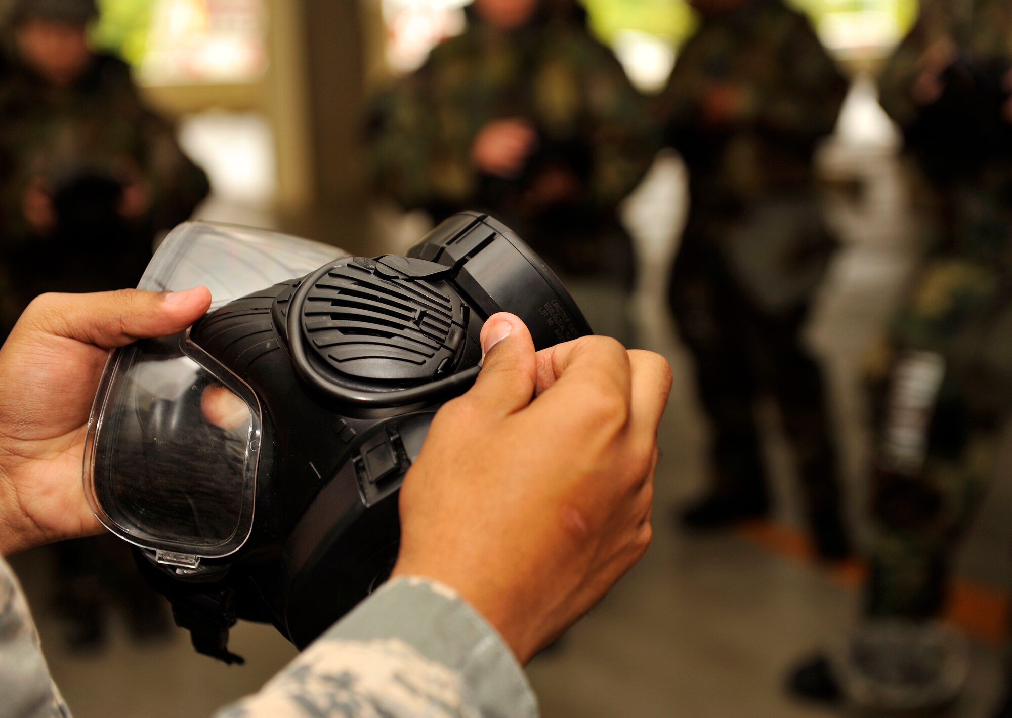 U.S. Air Force Airman 1st Class Jomar Morales-Colon, 18th Civil Engineer Squadron emergency management, briefs ground crew ensemble maintenance during mission assurance command and control rodeo training on Kadena Air Base, Japan, April 16, 2014. The 18th Civil Engineer Group holds at least one training before Phase II exercises to give Airmen a refresher and prepare them for the next exercise. (U.S. Air Force photo by Naoto Anazawa)