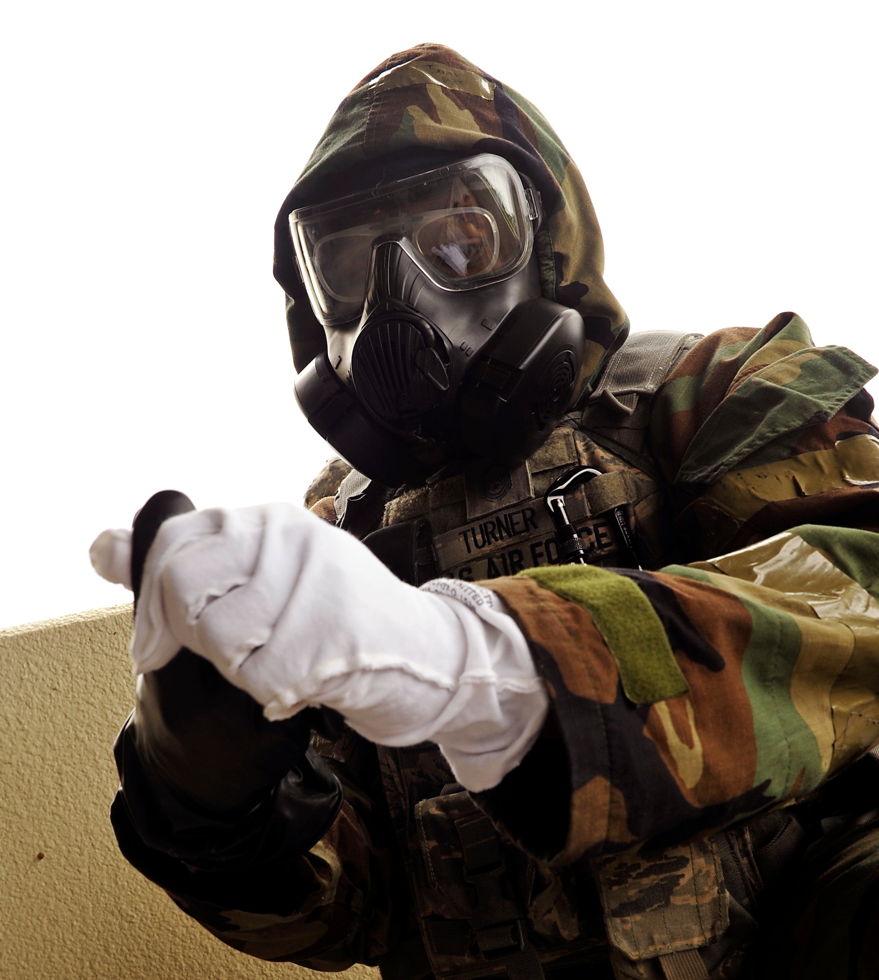 U.S. Air Force Master Sgt. Tyson Turner, 18th Security Forces Squadron flight chief, wears gloves during mission assurance command and control rodeo training on Kadena Air Base, Japan, April 16, 2014. The training is important, as it helps prepare Airmen for wartime contingencies. These skills are vital to helping ensure force survivability and mission continuation after an enemy attack. (U.S. Air Force photo by Naoto Anazawa)