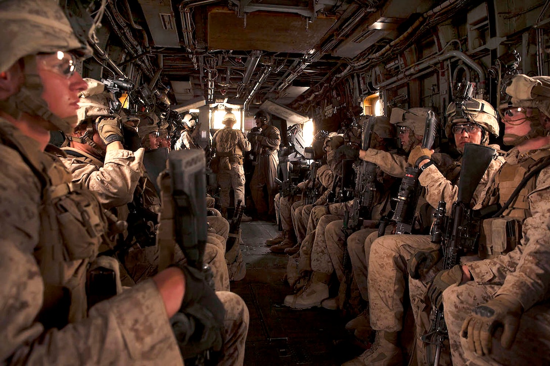 Marines sit inside a CH-53E Super Stallion helicopter before helicopter raid training as part of a weapons and tactics course for instructors on Yuma Proving Ground, Ariz., April 9, 2014. The training teaches the basics of Marine Corps aviation and provides strategy, tactics and execution experience. The Marines are assigned to  2nd Marine Division's India Company, 3rd Battalion, 6th Marine Regiment.