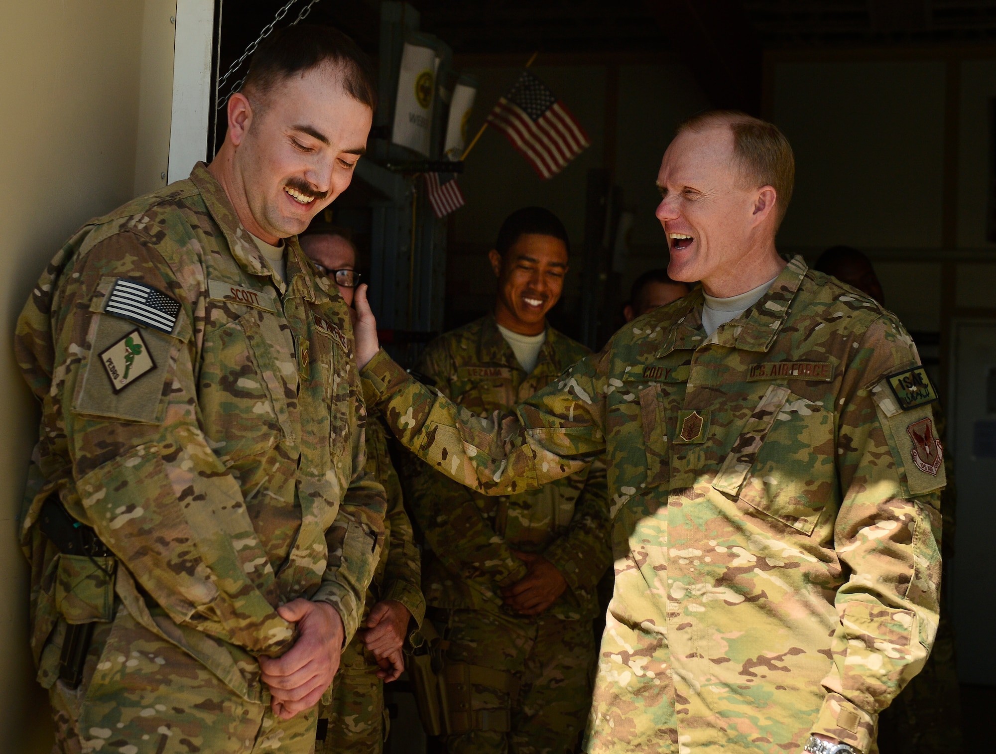 Chief Master Sgt. of the Air Force James A. Cody, shares a laugh with Staff Sgt. Clint Scott, 83rd Expeditionary Rescue Squadron, aircrew flight craftsman, during a visit to Bagram Air Field, Afghanistan, April 13, 2014. Cody visited Bagram Air Field during his trip through Afghanistan to encourage, inform and thank Airmen for their hard work supporting Operation Enduring Freedom. His visit to Bagram concluded with a 60-minute question and answer all-call with nearly 500 Airmen. (U.S. Air Force photo by Staff Sgt. Vernon Young Jr.)