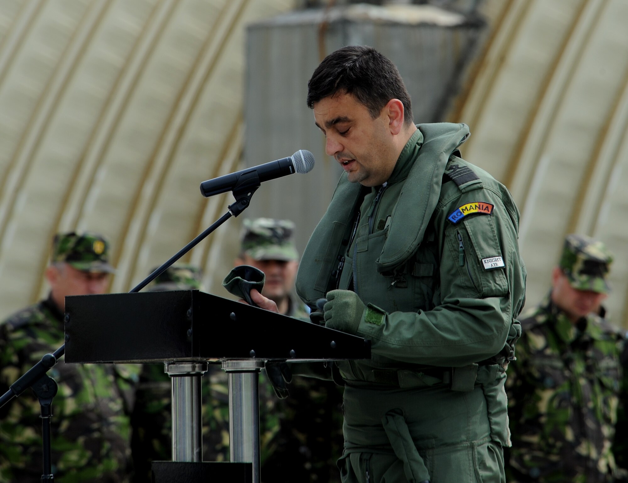 Romanian air force Cmdr. Adrian Motorga, 711th Squadron commander, shares his thoughts during the closing ceremony of Exercise Dacian Viper 2014 at Campia Turzii, Romania, April 17, 2014. The exercise, which began April 10, enhanced interoperability and readiness between the NATO partners through combined air operations between F-16 Fighting Falcons from Aviano Air Base, Italy, and MiG-21 Lancers from the 71st AB. (U.S. Air Force photo/Staff Sgt. R.J. Biermann)