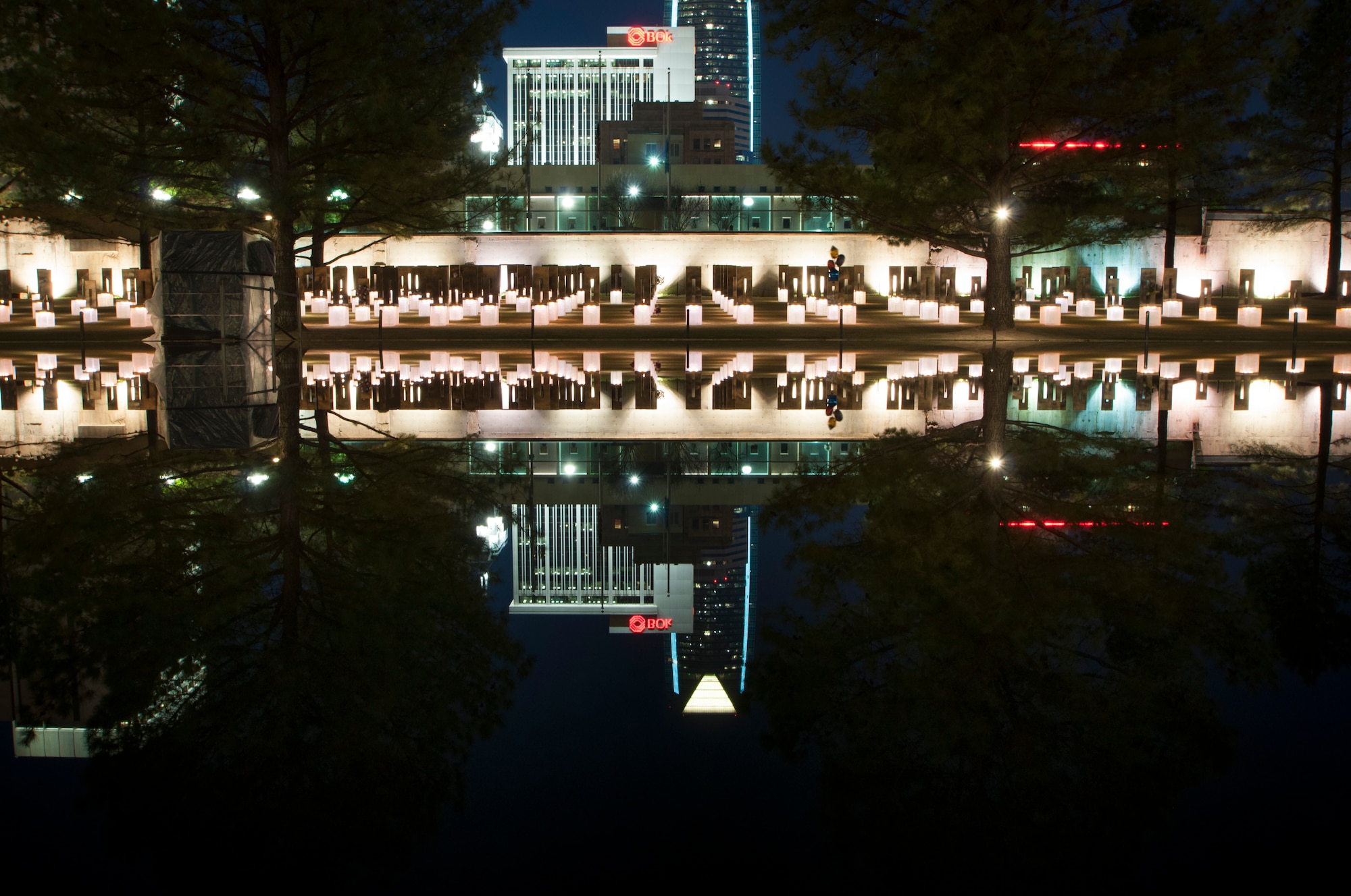 The Field of Empty Chairs casts its reflection in the Reflecting Pool.  Nineteen years ago the Alfred P. Murrah Federal Building stood in that field and overlooked what was once N.W. 5th St.  (U.S. Air Force photo/Senior Airman Mark Hybers)