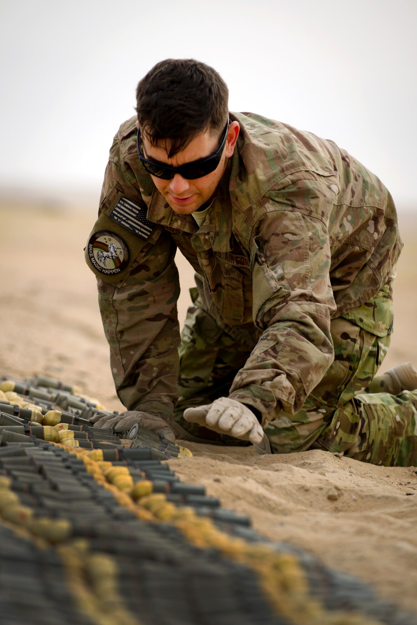 Staff Sgt. Paul Orosz, an explosive ordnance disposal technician, carefully arranges munitions slated for disposal at an undisclosed location in Southwest Asia.  Orosz is deployed to the 386th Expeditionary Civil Engineer Squadron from the 52nd CES at Spangdahlem Air Base, Germany. (U.S. Air Force photo by Senior Master Sgt. Burke Baker)(This image was manipulated for security purposes)    